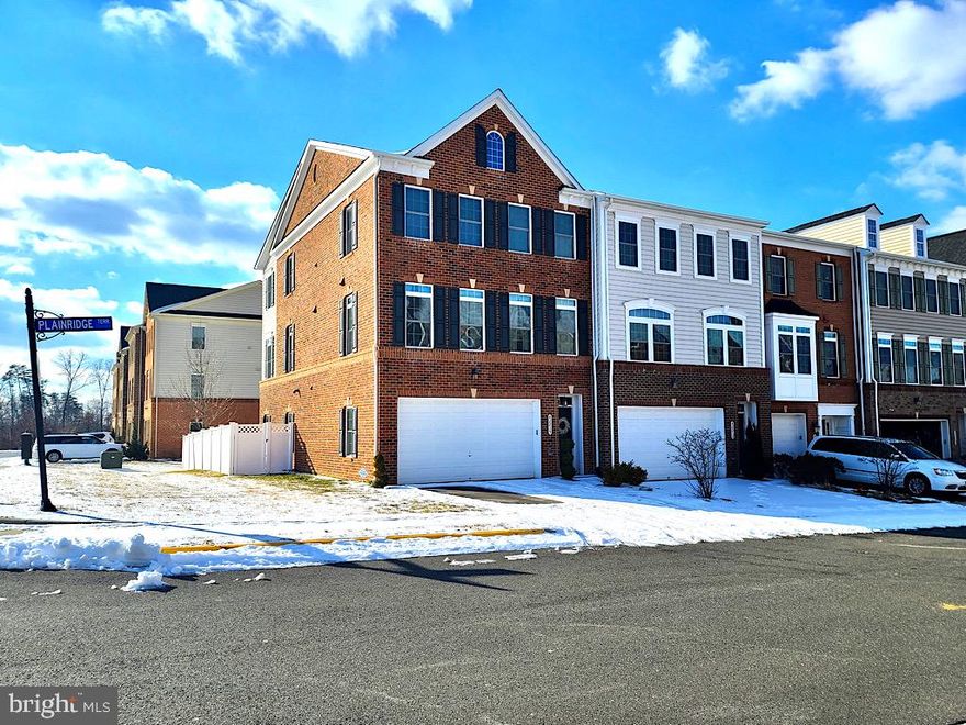 Spacious and airy, brick front end unit with two car garage and endless upgrades! Built in 2014 this townhome features a main level with wide plank hardwood floors, stone electric fireplace with bookshelves, an extended kitchen island with granite countertops, and a walk-in pantry. The large deck has space for a table and seating area. Upstairs, the HUGE master bedroom has a wiring for a ceiling fan, walk-in closets and a spa-like master bath with seamless shower door, dual shower heads and upgraded cabinetry and tiling. The second bedroom is wired for internet and third bedroom is wired for cable.  The hall bathroom offers dual sinks and cabinetry. The laundry room is located on the upper level which will include the washer and dryer. The basement hosts a third full bath, luxury vinyl plank flooring, built in surround sound and a projector TV. The home is energy efficient and has a tankless water heater for your convenience. Enjoy all the beautiful amenities Virginia Manor has to offer and the convenience of Aldie living, close to St Paul VI Catholic High School, shops and restaurants and just a short drive to wineries and the mountains.