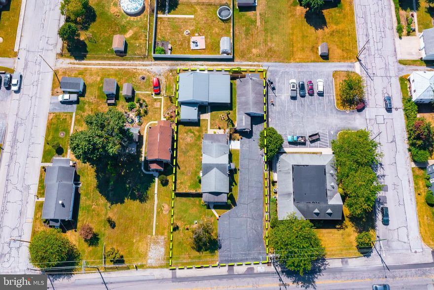 Hobbyists, enthusiasts, artists, entrepreneurs, collectors, and mechanics—you’re all invited! Feel free to bring along your toys, hot rods, classic cars, travel trailers, motorhomes, boats, and motorcycles—there’s ample parking space for everything on this property. Located in the township of Conewago, this unique mixed-use space is zoned for Village Commercial but currently serves as a charming residence. Imagine living and working in this cozy 1.5-story Cape Cod home situated on a main road in Adams County, with convenient access to major shopping areas. This home features two bedrooms and one bathroom, along with a welcoming living room, dining room, laundry room, and a kitchen equipped with newer cabinets. The newly fenced side and backyard offers privacy and a safe space for your pets to roam. The home spans just over 900 square feet, while the garages boast a combined area of 1,916 square feet. The primary garage is an oversized four-car garage complete with an office, half bath, electricity, water, and gas heat. The second garage is also oversized, providing space for one car and a large workshop area, perfect as a personal retreat. Additionally, there’s a convenient two-car carport and a 16 x 16 shed with electricity for even more storage options.