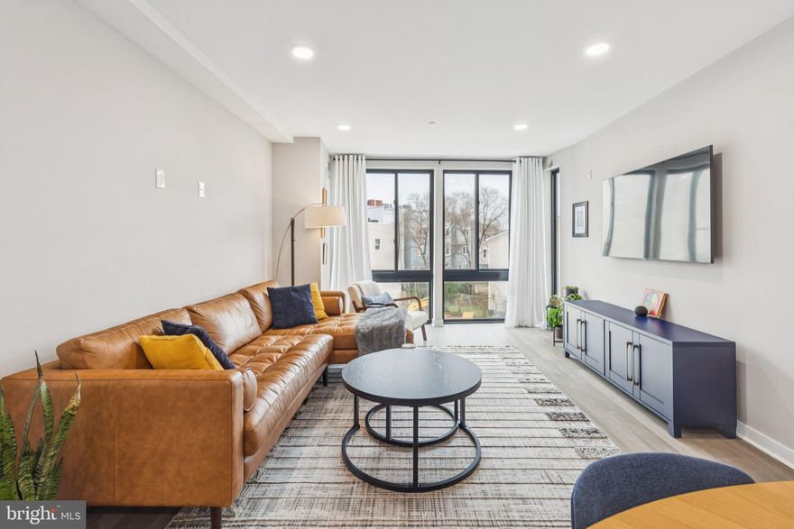 Welcome to Unit 301 at 1648-50 Ridge Avenue, located in the vibrant Francisville neighborhood. With 8 years remaining on the tax abatement and low condo fees, this beautifully constructed residence offers the perfect blend of modern design, convenience, and city living. Step inside to discover a thoughtfully designed space where contemporary style meets everyday functionality. Accessible by elevator, the home welcomes you with an open and airy layout filled with abundant natural light from large windows, creating a warm and inviting atmosphere throughout the living and dining areas. The chef’s kitchen is both stylish and practical, featuring modern white shaker-style cabinetry, stainless steel appliances, quartz countertops, a stylish light blue subway tile backsplash, and a walk-in pantry that provides exceptional storage. Located just off the living area is the in-unit washer and dryer, as well as a conveniently situated guest bathroom complete with a warm wood vanity, white subway tile shower, and contrasting gray tile floors. The spacious primary bedroom serves as a relaxing retreat, complete with a walk-in closet and a beautifully designed en-suite bathroom featuring a full rain shower and a warm gray vanity with generous countertop space. A second comfortably sized bedroom offers ample closet space and flexibility for guests, a home office, or additional living needs. Ascending to the rooftop, enjoy the spectacular shared deck, offering sweeping views of the Philadelphia skyline. Perfect for relaxing after a long day or entertaining guests, this rooftop space brings the city right to your doorstep. Nestled in a prime location, this home puts you just steps from your favorite neighborhood spots. Start your day with a coffee at Phin Cafe or Coffee Cream & Dreams, enjoy brunch or dinner at Bar Hygge, Vineyards Cafe, or Libertee Grounds, and take a leisurely stroll along Fairmount Avenue to discover an ever-changing mix of local shops and eateries. Cultural and recreational destinations like the Philadelphia Museum of Art, Eastern State Penitentiary, and nearby scenic parks are just minutes away, while public transportation right outside your door makes getting around effortless. Brewerytown is just a short walk away, and the Girard trolley can whisk you to Northern Liberties or Fishtown in just under 10 minutes. Whether you’re meeting friends, exploring the city, or soaking in the neighborhood’s charm, everything you need is within easy reach. Don’t miss the opportunity to experience modern city living at its finest at 1648-50 Ridge Avenue unit 301. Schedule your showing today and see everything this exceptional home has to offer.