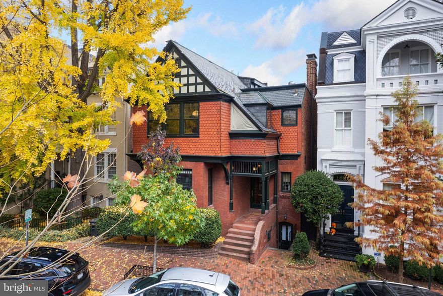 This fully detached Georgetown residence with commanding street presence is a rare example of a Queen Anne Victorian. The house was built by Kenderline & Parrett and designed by notable Architect Harvey L. Page for Navy Lieutenant Harrie Webster and his wife in 1885. The impressive residence has been thoughtfully updated, while maintaining its original historic details and character. The house features an abundance of natural sunlight, which is magnified by large windows, high ceilings, and skylights. It is featured in many books and articles including the Historic American Buildings Survey of the 24 Architectural Masterpieces of Georgetown.

The main level is a wonder. Somehow its original beauty and grace has been preserved even as modern updates and additions have been added to make it a functioning 21st century house and a comfortable and immensely livable home. The lovely front vestibule with transom windows leads to the gracious entry hall, which seamlessly transitions to the rest of the main floor rooms. The nearby dining room is large and elegant with a fireplace and an adjoining butler’s pantry. The well-appointed gourmet kitchen has high-end stainless-steel appliances, soapstone countertops, a breakfast bar, and a semi-circular bay, perfect for a sitting area or table. The neighboring sun-filled family room has been combined with the living room creating an immense open and light-filled space. Here French doors lead to the rear deck and exceptional garden. The original library is a marvel with built-in bookshelves, a wood-burning fireplace and abundance of original details. There is the added convenience of a powder room on this floor. The open-well stair to the second floor is also filled with original details including the balustrade and a double-hung lead stained glass window.

The second level has three light-filled bedrooms and two updated full bathrooms, including the wonderful primary suite. The generous primary bedroom has a fireplace, three oversized windows, and three closets. It adjoins the primary bathroom, which can also be accessed from the hall. Both of the additional bedrooms on this floor overlook the rear garden and terrace and utilize the hall bathroom.

The third floor has the most charming perch which makes an exceptional office space plus, and an additional den with original floors. The views and light are terrific here too.

The lower level of the residence provides a fully separate in-law/staff suite with front and rear entrances. There is a living room, kitchen, bedroom with a full bathroom, and a separate laundry room. This suite on the lower level can be completely closed off and separated from the main house. On the other side of the lower level is the primary laundry room with storage and a workshop.

The exceptionally large garden was part of the 2023 Georgetown garden tour. It is huge, both deep and wide, and best of all, level. It has mature plantings and trees which provide the grounds with privacy. A garden of this size is rarely available in Georgetown and offers beautifully layered landscaping with numerous entertaining spaces.