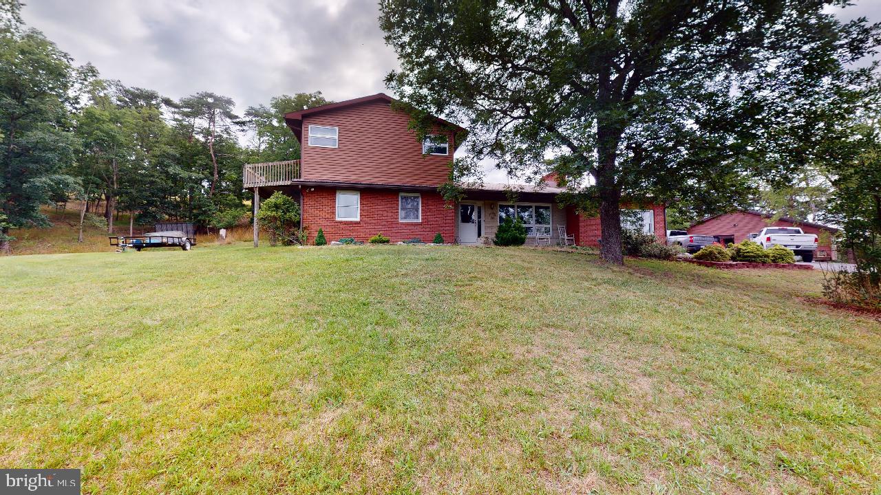 Unique 3 bedroom. 2-1/2 bath brick home on 3.43 unrestricted acres tucked away in the Short Gap area of Mineral County. You get that country feel but you're just minutes away from all of the amenities. With just under 3000 square feet of living space, this home has a lot to offer. The beautiful kitchen boasts an abundance of oak cabinets, granite countertops and stainless appliances, with a breakfast bar. There is a cozy feel in the living room when the electric fireplace is lit. The spacious dining room leads out to the 42x14 covered back patio. Enjoy the huge rec room, with sunroom area and built in wet bar. There is one main level bedroom with en-suite 1/2 bath, a full bath with tile shower and a large laundry room/ pantry. The second floor features an open 21x21 bedroom with two balconies, full bath including a double sink and a separate vanity and a walk-in closet and the third bedroom. There is plenty of space for the cars and toys in the garage. Take a look at the 3D tour!