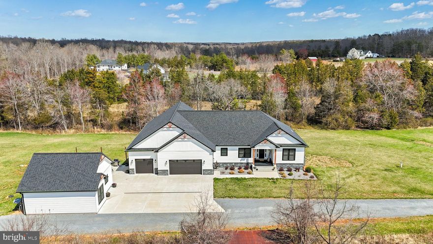 Custom Barn-Style Beauty with Main House & Cottage on 3.86 Acres!

Move-in ready and truly one of a kind, this stunning custom-built barn-style home offers an incredible blend of modern luxury and country charm. The fully maintenance-free exterior, concrete driveway, and attached three-car garage (plus a finished bonus room perfect for a gym or hobby space) set the tone for effortless living.

Inside, the open floor plan is designed to impress, featuring luxury vinyl plank flooring throughout, soaring vaulted and tray ceilings, and an abundance of natural light. The kitchen is a chef’s dream with a large granite island, wall oven, gas cooktop, stainless steel appliances, wine fridge, and an expansive walk-in pantry. The laundry room conveniently connects to the primary suite, which boasts a spa-like bath and custom barn doors.

Enjoy the spacious sunroom, multiple porches, patios, and decks—perfect for indoor-outdoor living! The lower level offers another bedroom, full bath, and endless potential to customize as your own.

The adorable 1-bedroom, 1-bath cottage is an absolute gem—ideal for guests, an Airbnb, or an in-law suite, with the same high-end finishes as the main house.

This rare find is meticulously maintained, in mint condition, and set in a peaceful location. With ample concrete space for outdoor entertaining, a versatile cottage, and a spacious garage, this property is truly a must-see. Don't miss out on this exceptional opportunity!