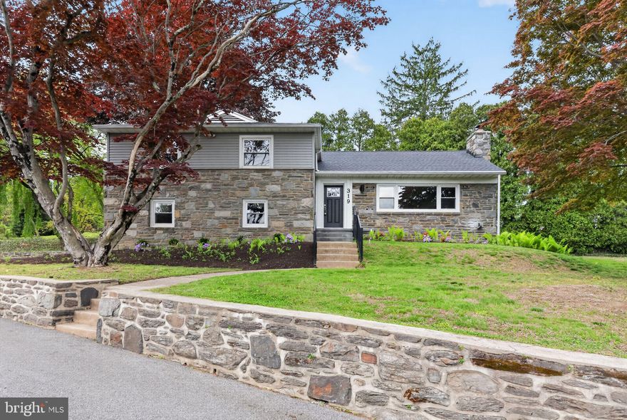 Welcome to 319 Crestview Circle, a stunning stone residence offering 3 bedrooms, 2.5 baths, and over 2,100 square feet of beautifully updated living space. Situated on more than half an acre, this home is tucked away on a quiet, private circle while remaining conveniently located near major highways, just 15 minutes from Philadelphia International Airport, and within the award-winning Wallingford-Swarthmore School District. Opportunities in this highly sought-after neighborhood are truly rare.

From the moment you arrive, you are welcomed by a long private driveway, exceptional curb appeal, and access to the attached two-car garage. Inside, a sun-filled living room showcases expansive picture windows, a cozy fireplace, and new luxury flooring that flows seamlessly throughout the home.

Extensively renovated with a focus on quality craftsmanship, the home features a brand new roof, upgraded electrical and plumbing systems, and new insulation and drywall in portions of the home—offering peace of mind for years to come. Nearly every detail has been thoughtfully curated and meticulously updated.

At the heart of the home is the beautifully reimagined kitchen, featuring high-quality wood cabinetry, stainless steel GE appliances, quartz countertops, and a peninsula with seating. The kitchen opens effortlessly to the dining area, creating an ideal setting for both everyday living and entertaining.

Adjacent to the main living space, the spacious, fully conditioned sunroom provides a seamless extension of the home and overlooks the private backyard. Equipped with a new mini-split system for efficient heating and cooling, this space is perfect for year-round enjoyment, whether relaxing or hosting gatherings.

Upstairs, the primary suite offers a tranquil retreat with generous closet space and a beautifully renovated ensuite bath appointed with elegant marble tile. Two additional well-proportioned bedrooms, each featuring ceiling fans and ample closet space, share a tastefully updated hall bathroom.

The lower level features a comfortable family room with convenient access to a stylishly renovated powder room and the attached garage. An additional flexible space on this level is ideal for a home office, gym, or playroom, while the basement houses the laundry and utility areas.

Outdoors, the property continues to impress with mature landscaping, thoughtfully designed plantings, a storage shed, and a new Trex deck with railing—perfect for outdoor entertaining.

Residents enjoy convenient access to the scenic Pendle Hill Trail, which connects to the Leiper Smedley Trail, offering miles of walking, running, and outdoor recreation.