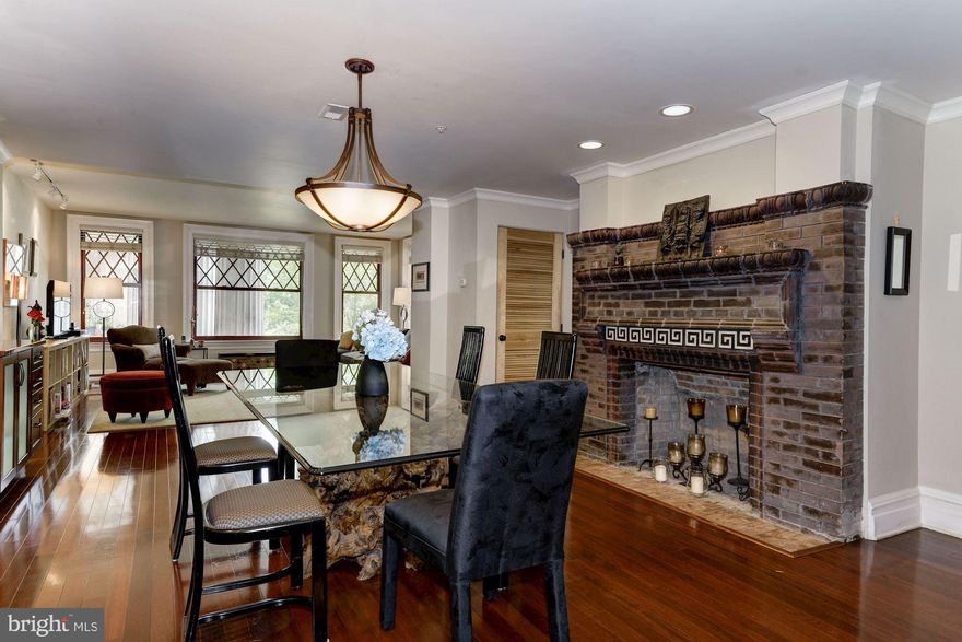 A precious gem in the residential treasure trove that is National Park Seminary. One-of-a-kind community comprises a virtual magical mystery tour of unique homes, luxury condominiums & townhomes and apartments.The campus is a destination. This home boasts one of the largest floor plans at 2265 sf on 2 levels; lives like  detached home without exterior maintenance. A brick & stone hearth is the focal point of the main living area; a rare artifact harkens back to another time with egg&dart and Greek key stone trim;  your friends and guests will be gobsmacked. A sleek modern kitchen seamlessly integrates with the rich historic character. Diamon mullions punctuate the upper half of the large windows adding a natural decorative element. Brazilian cherry hardwoods finish the main level with gravitas. Luxurious elements added by the current owner enhance the aesthetic...a lavish built-in bar with mirror backdrop and granite surface; an office nook with cherry built-in bookcase cleverly concealed while adding significant storage, master closets with frosted french doors and auto lighting in the Master dressing area. A huge private porch off the main level extends the entertaining space outside in 3 seasons, any weather. Finally, 2 deeded parking spaces are included. Price is lower than assessed value of the unit alone and lower than current owner paid before adding $50k in upgrades!  ISO the visionary to claim this prize!