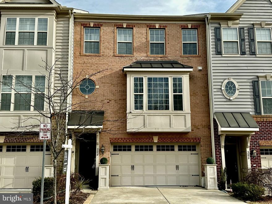 Welcome to this beautifully customized 4-bedroom, 3.5-bath townhome in the heart of Admirals Ridge, offering approximately 3,000 square feet of thoughtfully designed living space across three fully finished levels. Designed with flexibility in mind, this home seamlessly supports today’s lifestyles with dedicated zones for work, relaxation, entertaining, and comfortable living.  The middle level showcases an open-concept layout centered around a gourmet kitchen featuring granite countertops, a gas range, stainless steel appliances, and abundant cabinetry. The space flows effortlessly from a charming front breakfast area with a box bay window to a spacious living room—ideal for both entertaining and everyday living.  Just off the living room, a light-filled sunroom-style bump-out creates the perfect space for a reading nook, play area, or indoor garden. Sliding glass doors lead to a private, fenced backyard, offering a true indoor-outdoor connection with room for pets, play, or quiet enjoyment. Upstairs, the primary suite is a true retreat with a walk-in closet and spa-inspired bath complete with a soaking tub and separate shower. A rare rear bump-out adds a private sitting room or office—perfect for remote work or a quiet escape. Two additional bedrooms and a full bath complete the upper level. The finished entry level features a private bedroom and full bath, ideal for guests. A professionally installed stairlift provides enhanced accessibility between the lower and main levels. Additional highlights include hardwood floors on the main level, a two-car garage with interior access and a built-in Level 2 J1772 electric vehicle charger, and an HOA that covers lawn care, snow removal, and more. Conveniently located near shopping, major commuter routes, and downtown Annapolis, this home offers both comfort and convenience. One of the most versatile layouts in Admirals Ridge, this exceptional townhome combines distinctive upgrades, bright and open living spaces, and thoughtful features to accommodate a wide range of buyer needs.