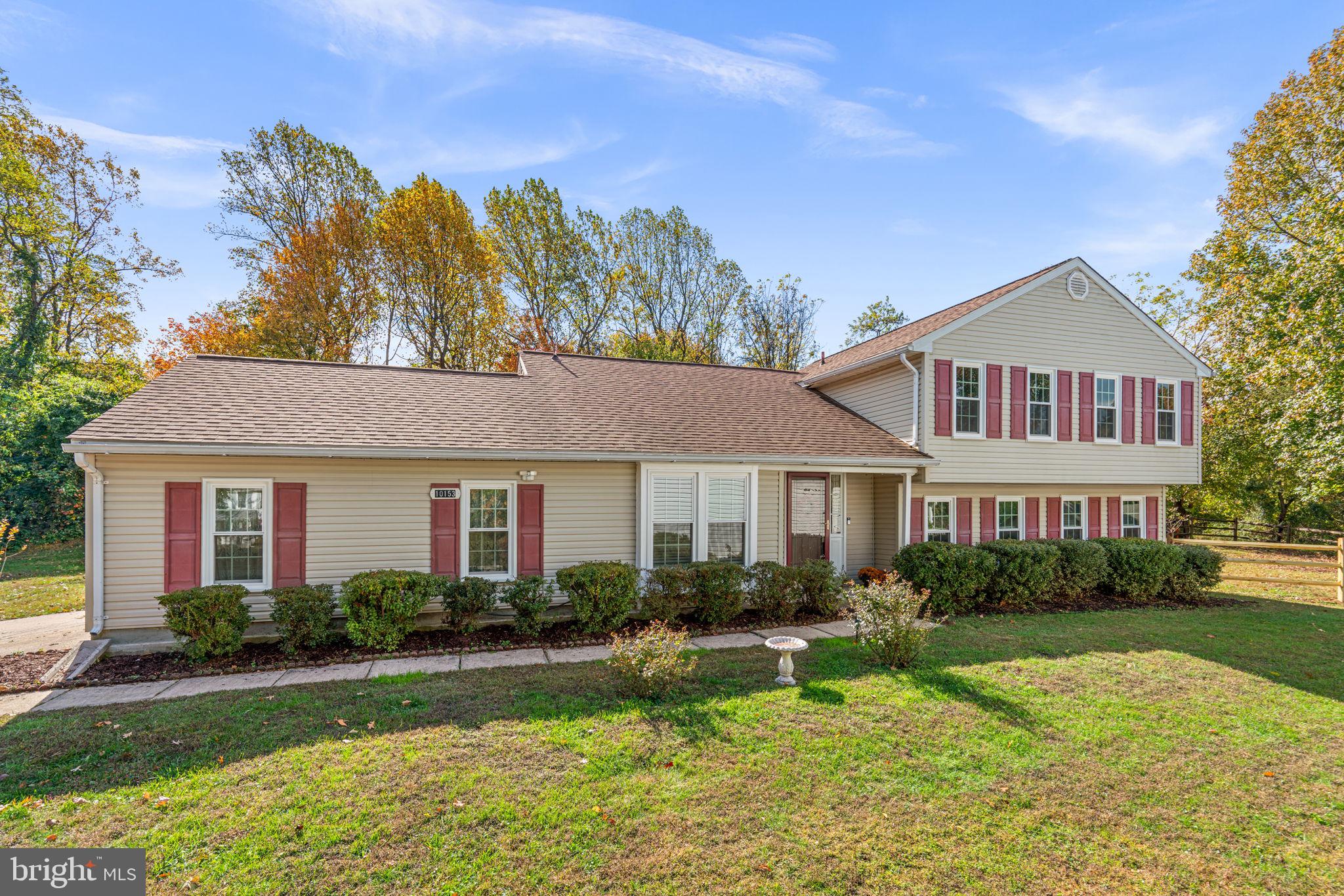 Charming Colonial offering 4 bedrooms, 2.5 bathrooms, a 2-car garage with a TESLA EV charger, and 2,608 finished square feet on a private, tree-lined lot in desirable Kings Contrivance. Hardwood floors (2023) flow throughout the main level, beginning in the welcoming foyer and extending into the spacious living room with access to the deck. Adjacent to the foyer is the updated (2025) eat-in kitchen and breakfast area, featuring recently installed quartz countertops, a garbage disposal, and a sink, as well as stainless steel appliances, a modern backsplash, white cabinetry with glass-front accents, luxury vinyl plank flooring, and convenient garage access. Step down from the foyer to a cozy dining or sitting room, highlighted by a wood-burning fireplace framed by built-in bookcases and tile detailing—a perfect space for gatherings or quiet evenings. Down the hallway, you’ll find a powder room (updated in 2025), a utility room with a washer and dryer (2023), and an additional bedroom or potential home office for flexible living.
Upstairs hosts three generous bedrooms and two full bathrooms (updated in 2025), including the primary suite with hardwood floors, a walk-in closet, a separate vanity/makeup station, and a private attached bath. The upper guest bathroom features recently upgraded sink and shower faucets, as well as luxury vinyl flooring. The fully finished walk-up lower level provides a spacious recreation room with a designated home gym area, a versatile bonus room, and a storage area, offering plenty of space for relaxation, hobbies, or guests. Outdoor living shines with a composite deck, reinforced side panels, lush landscaping, a gazebo, and a fenced side yard with garden beds backing to a peaceful open area lined with trees. The exterior has been professionally power-washed, and the front bushes have been neatly trimmed for enhanced curb appeal.  Additional updates include freshly repainted bathrooms, luxury vinyl flooring added in all three bathrooms, an HVAC system replaced in 2024, and newly added blinds on all first-floor windows and the deck door.