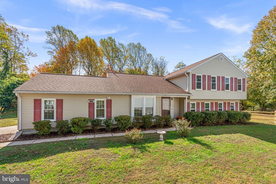 Charming Colonial offering 4 bedrooms, 2.5 bathrooms, a 2-car garage with a TESLA EV charger, and 2,608 finished square feet on a private, tree-lined lot in desirable Kings Contrivance. Hardwood floors (2023) flow throughout the main level, beginning in the welcoming foyer and extending into the spacious living room with access to the deck. Adjacent to the foyer is the updated (2025) eat-in kitchen and breakfast area, featuring recently installed quartz countertops, a garbage disposal, and a sink, as well as stainless steel appliances, a modern backsplash, white cabinetry with glass-front accents, luxury vinyl plank flooring, and convenient garage access. Step down from the foyer to a cozy dining or sitting room, highlighted by a wood-burning fireplace framed by built-in bookcases and tile detailing—a perfect space for gatherings or quiet evenings. Down the hallway, you’ll find a powder room (updated in 2025), a utility room with a washer and dryer (2023), and an additional bedroom or potential home office for flexible living.
Upstairs hosts three generous bedrooms and two full bathrooms (updated in 2025), including the primary suite with hardwood floors, a walk-in closet, a separate vanity/makeup station, and a private attached bath. The upper guest bathroom features recently upgraded sink and shower faucets, as well as luxury vinyl flooring. The fully finished walk-up lower level provides a spacious recreation room with a designated home gym area, a versatile bonus room, and a storage area, offering plenty of space for relaxation, hobbies, or guests. Outdoor living shines with a composite deck, reinforced side panels, lush landscaping, a gazebo, and a fenced side yard with garden beds backing to a peaceful open area lined with trees. The exterior has been professionally power-washed, and the front bushes have been neatly trimmed for enhanced curb appeal.  Additional updates include freshly repainted bathrooms, luxury vinyl flooring added in all three bathrooms, an HVAC system replaced in 2024, and newly added blinds on all first-floor windows and the deck door.