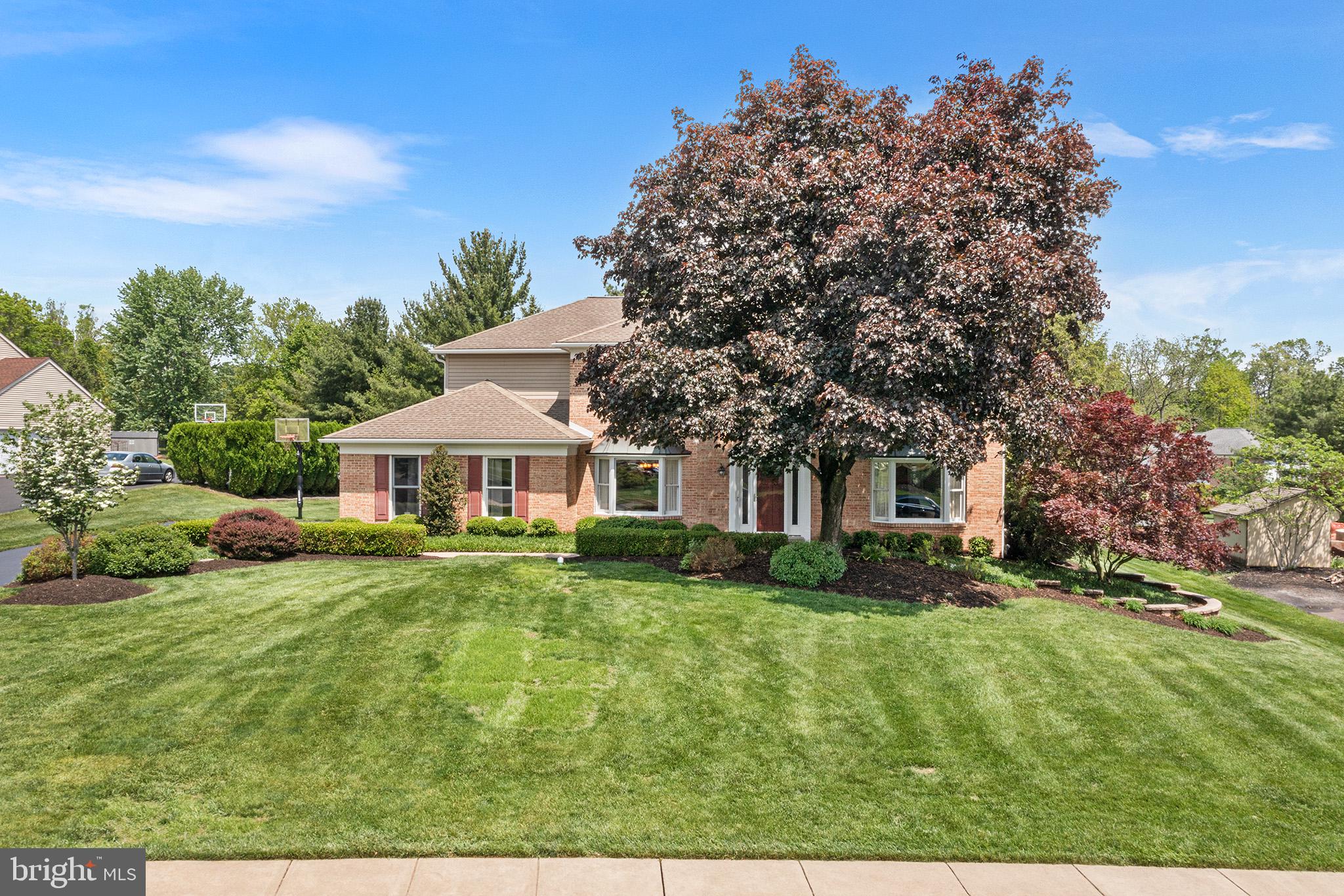 Offer deadline Sunday 5/11 at 5pm. Welcome to this beautifully maintained 4-bedroom, 2.5-bath home located in the prestigious Gwynedd Shires neighborhood of Upper Gwynedd Township. Perfectly situated on a spacious, manicured lot, this home offers timeless curb appeal with mature landscaping and classic brick-front charm. Step through the front door to an inviting open-concept first floor featuring gleaming hardwood floors and a seamless flow between the living, dining, and kitchen areas. The kitchen boasts rich wood cabinetry, granite countertops, a peninsula with seating. The 2007 sunroom addition allows lots of natural light and perfect for relaxing or entertaining year-round. The cozy gas fireplace adds warmth and character to the living space, while the mudroom with built-in organizer keeps things neat and functional. The first floor of this center hall colonial is completed with a powder room, hall closet, and formal dining and living rooms that flow seamlessly into the inviting family room. Upstairs, retreat to the expansive primary suite, complete with two walk-in closets, a private study, and a luxurious ensuite bath renovated in 2018. Three additional bedrooms and another full bath—also renovated in 2018—complete the second level with plenty of room for family or guests. The finished basement offers endless possibilities as a rec room, home gym, or additional living space. Outside, you’ll love the brick paver patio, ideal for outdoor dining and entertaining.