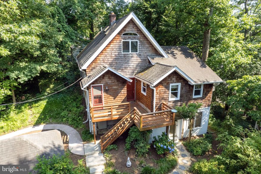 This is one of a kind - charming cottage nestled up on the hill with privacy and winter waterviews!   This gem offers 2 separate garages - one deep 2 car garage with small driveway in front and parking pad on the side and another 1 car garage!  You can stroll up the flat path or walk up the steps to the lower patio and deck.  
Walk into an open living room with Pine floors and sunroom area for extra space, bonus large office office,  The main level consists of 3 bedrooms and full bath, kitchen and pantry area, newer windows.  The upper level is an amazing suite with sitting area with lots of options, double doors leading to the primary bedroom with vaulted ceilings and skylights and primary bath, new 2024 Carrier heat pump.

Lower level makes for a perfect office/studio/rec room lined with windows and full bath.  There is also an unfinished are for storage and work bench.  The gas furnace and hot water heater are both 2018.  Walk around the property and enjoy all the charming features.  As a resident of this water privileged community, you'll have access to this super active community with boat slips, boat ramp, pavilion, beach, swim up platform, BBQ & picnic area, playground, basketball & tennis/picklelball courts, along with Chase Creek community pool!