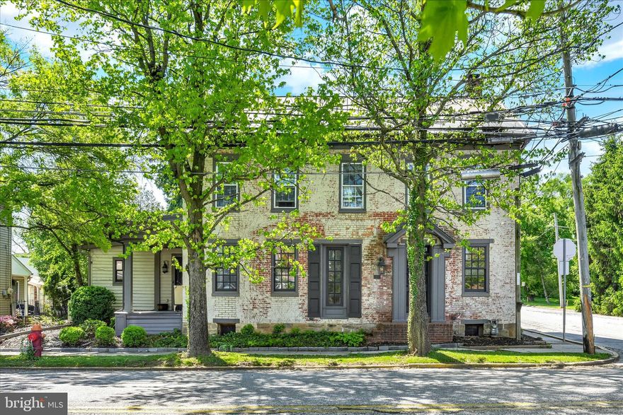If you love character and quality construction, you will love this 5 bedroom, 4 full bath, 2700 sq. ft., circa 1858 triple-thick brick, metal roof home right in the heart of New Oxford, known for it antique stores and beautiful town square. High ceilings with exposed beams, exposed brick walls and floors recovered from a barn set the tone, along with wavy glass double-pane windows, exterior walnut trim work, Williamsburg-approved lights in foyer and stairs to attic, metal flooring thresholds, deep window sills, stone-front fireplace and crown moldings. Kitchen shines with granite countertops,  porcelain sink, beveled glass-front cabinet and a skylight.   Bathrooms feature Kohler and Delta fixtures, toilets and sinks.  Convenient 1st floor laundry room. The outside space is just as charming with wisteria covered arbor, beautiful landscaping, black aluminum fence and paver driveway.  House had once been used as a multi-unit rental, so there are kitchen hookups in one of the upstairs bedrooms as well as in the basement.  There are 2 additional fireplaces in the basement, but sellers have not attempted to use and the gas is capped.  Come take a look before it's gone!