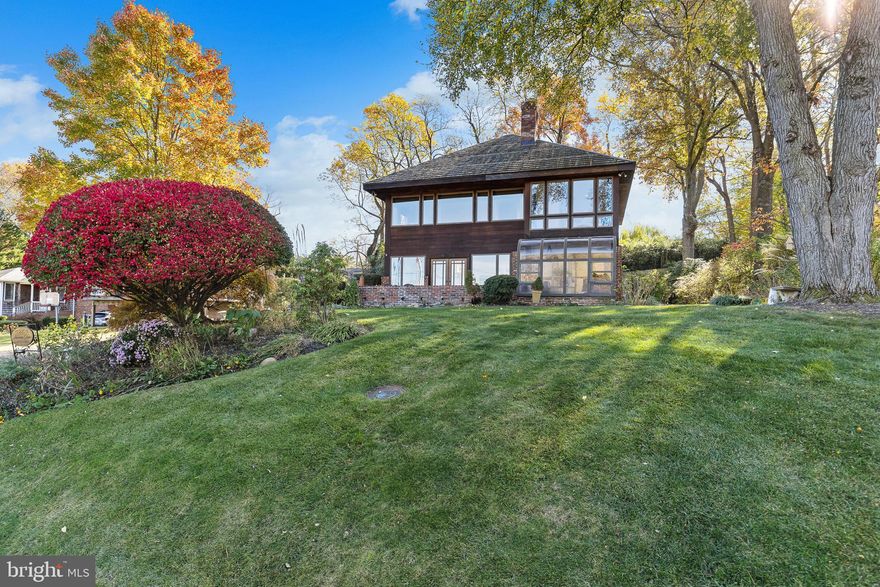 WOW! WHAT A VIEW OF LAKE BARCROFT! Stunning Contemporary with year-round wide-open views of Lake Barcroft from nearly every room of the house! This completely renovated 4 bedroom and 3 bath home sits just steps from one of Lake Barcroft's beaches providing unparalleled lakefront views and experiences! Contemporary redwood siding and oversized windows throughout invite the outdoors in and harmonize seamlessly with the modern design. Thoughtfully renovated throughout with high-end finishes, this home truly has it all! The open main level floor plan includes a fully renovated kitchen with custom Neff cabinetry, granite counters, and top-of-the-line stainless steel appliances. To enhance your comfort underfoot, Mannington laminate flooring is luxuriously cushioned with a cork underlay. The spacious living and dining area is enhanced by a gas fireplace, and French doors open to an expansive slate patio, an idyllic perch to savor serene lake vistas. Additionally, the main level boasts a family room, a bedroom, a full bath, and a sunroom. Ascend the floating staircase to discover an opulent primary suite featuring a wall of windows with panoramic lake vistas. The primary bath is a spa-like retreat with an oversized walk-in rain shower, Grohe fixtures, custom tiles, floating dual sinks, and high-end cabinets. A huge walk-in closet leads to the convenient bedroom-level washer and dryer. French doors open to a versatile, attached office or an additional bedroom. Completing the upper-level area is an additional bedroom and hall bath with custom tile and Kohler fixtures. Nestled on a charming lot, this property boasts a private backyard, exquisite landscaping, and an oversized 1-car carport. Embrace lakeside living in this extraordinary Lake Barcroft retreat. Seconds to Lake Barcroft’s 5 sandy beaches for swimming, boating, fishing, and more! 1 block to the Metro bus stop, and easy access to commuter routes (Rts 50/66/495) Arlington, Tysons, DC, and more! Don't miss your chance to call this gorgeous home your own!