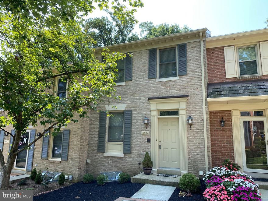 Lovely brick townhome in the beautifully maintained community of Manor Village backing to Manor Country Club.  This home features 2 Primary Bedrooms with Full Baths on the upper level.  Beautiful hardwood floors on main level.  New carpet on upper and lower levels.  Fireplace in Family Room on lower level.  Half baths on both main and lower levels.  Newly stained raised deck backs to trees creating a private, peaceful setting.  Freshly painted throughout.  Meticulously maintained community provides two assigned parking spaces.  No pets.