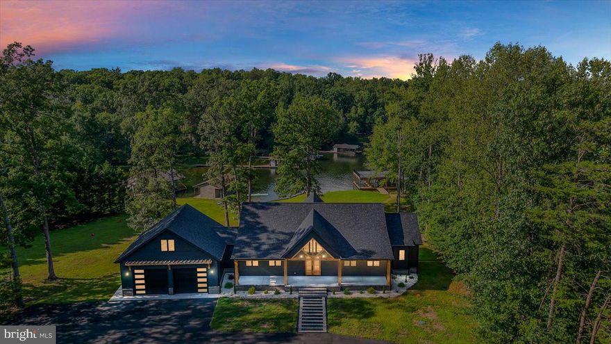 Now is your chance to own this exceptional value on this brand new, move in ready luxury home! Take a glimpse into unparalleled waterfront excellence at Lake Anna, Virginia.  This exquisite recently-constructed tribute to lakeside opulence truly has no match.  Overlooking the private side of Lake Anna, the builder of this impressive custom-built oasis has spared no expense; this 5,000+ square foot waterfront fortress exudes luxury living and meticulous craftsmanship in every corner.  This home has the potential to convert and/or finish rooms to be a 6 bedroom home!  Make entry through the massive custom wood doors to discover soaring 20+ foot ceilings, massive windows showcasing your water views, 7 1/4 inch-wide French white oak wood plank flooring, gorgeous fixtures, and large open spaces.  The cavernous great room openly transitions into an oversized gourmet kitchen with a massive center island that displays an electric fireplace with blower, exquisite quartz countertops, a tremendous built-in coffee bar framed in custom trim, and stunning high-end Italian stainless appliances.  The 6 burner gas stove with griddle, high-end black cabinetry, and champagne hardware set the tone, along with your luxurious walk-in pantry that features wood countertops, white cabinets, and a full size beverage cooler.  The large primary bedroom has stunning 10 foot ceilings, en suite bathroom with double vanity, incredible standalone soaking tub, a marble-tiled walk-in frameless shower with rainfall and handheld shower heads, and enormous adjoining custom walk-in closet that is larger than most bedrooms, offering custom shelving and a center island with drawers.  There is one additional bedroom on the main level, a full bath, half bath and laundry.  The finished walkout basement features a large main space perfect for a family room/rec area and a separate flex room with wet bar / kitchenette, that could make a great movie room or be converted easily into a fifth bedroom.  There are two additional lakeside bedrooms, each with their own private full bathroom and walk-in closet.  The downstairs level also includes a second attached garage with lake-facing entry, perfect for storing boats, water toys, lawn equipment or other personal property.  Park your vehicles in your oversized (1,188 square foot) opulent attached garage with showroom mirror-polished floors, and large room above that could be finished into a 6th bedroom, apartment or bonus room.  Your nearly-flat, park-like backyard gently connects with your 125+/- feet of shoreline at the lake in a no wake cove, where your large, double-decker 2,000+ square feet, two-slip boathouse with electric lifts was recently constructed, including a screened room, storage, and a massive second level sun deck for sunbathing, good times and entertaining your family and friends.  It doesn't get any better than this.  Come see for yourself and make the move to elevate your lifestyle at Lake Anna.  Short term rentals are permitted and this retreat would make a high income-producing investment asset.  See projected rental revenue in MLS documents!