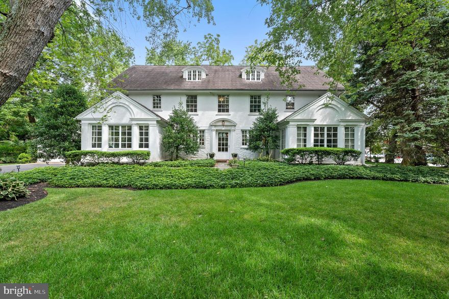 Built in 1919 in the estate section of Merion Station, this grand manor home with attached 3 car garage features over 5000 sq. ft. of living space and 7 bedrooms with 5 updated bathrooms. As you enter, you are greeted by the wide center hall with hardwood flooring, a coat closet and a half bath neatly tucked under the stairs. To the right is a large living room with wood burning fireplace and picture window. Continue through glass-paned french doors to the family room, surrounded by windows on three sides. To the left of the center hall is the formal dining room with large picture window, which flows into the eat-in kitchen. The kitchen is very spacious for the age of the home and features a large island, Sub Zero refrigerator and indoor grill. Off of the kitchen is a small room, currently used as an office. There is a tiled mudroom with pantry closets leading to the attached 3 car garage addition (very rare for a house built in 1919.) The second level includes a primary suite with lovely new bathroom featuring Carrara marble, a walk-in steam shower and double vanity. A small bedroom was turned into a walk-in closet with custom closet built-ins. There are 2 additional bedrooms, and one has an attached, bright “sleeping porch” which was used as a homework room. Also on this floor is a hall bathroom with shower/tub combo, an antique pedestal sink and a convenient laundry room. The third level is a wonderful surprise with 4 bedrooms and 2 new full bathrooms, both with gorgeous tile work and large showers with frameless glass enclosures. There is a door that separates two of the bedrooms and the hall bathroom and this space can utilize cool backstairs that go all the way down to the kitchen. The basement is partially finished with new carpeting and can be accessed from the kitchen or the mudroom. The rear of the house features a slate patio for entertaining. This stately home is graced with beautiful landscaped grounds in the award winning Lower Merion school district, walkable to shops and places of worship.