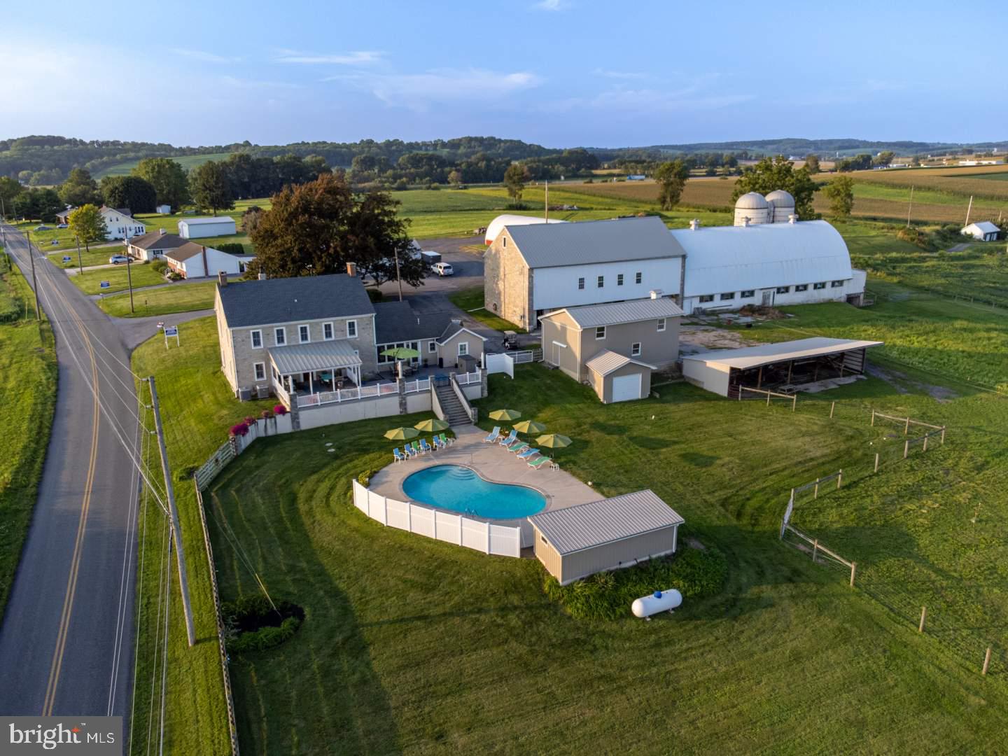 Offered for sale is two parcels totaling approx. 13 acres. Also available is the adjoining property at 87 S Kemp Rd., MLS# PABK2049820
This gorgeous 1830’s Circa 2½ sty. upscale 5 BR stone farmhouse has been expertly renovated showcasing original character seamlessly with modern convenience and an open floor plan and consists of approx. 5,425 SF. The home features artisan workmanship w/hand scraped white & red oak wood floors, Amish made stone wood fired bake oven, post & beam living room w/2 story cathedral ceilings, exposed stone, 20” window sills, built-in window candles, and so much more! The first floor has a large tiled foyer w/radiant floor he t which extends through the bright sunroom overlooking the deck and pool area, the half bath and through the laundry room equipped with a commercial refrigerator/freezer, a convection oven/microwave, large stainless-steel sink, washer & dryer and lots of cupboards for storage. The kitchen, dining room and family room are all open w/exposed beams and feature beautiful hand scraped red and white oak floors. The kitchen features rich cherry stained cabinets w/black-stone countertops and tiled backsplash, stainless-steel refrigerator/freezer, dishwasher and Dacor 6 burner commercial stove w/dbl. oven, an island w/butcher block top and a gorgeous stone wood-fired bake oven. The family room has a brick gas fireplace, an open staircase to the second floor and a hallway that leads to the 2-story post and beam addition. This addition features tiled radiant floor heat, 2-story wood cathedral ceiling w/open beams, ceiling fans and exposed stone walls and consist of a living room w/stone wood burning fireplace, a bathroom with a glass shower and vessel sink and an office w/built-in filing cabinets. The second floor consists of 3 bedrooms w/hand scraped red & white oak floors, two full baths with tiled floors and a closet washer & dryer. The master bedroom has a 7x13 walk-in closet complete w/organizers & drawers, the master bathroom has a dbl. bowl vanity, glass corner shower, and towel warmer, the other 2 bedrooms have walk-in closets w/organizers, and the other full bath has a dbl. bowl vanity and jetted tub. The third floor has two bedrooms with hardwood floors and a 7x7 walk-in closet. The home has a full basement, 1 car attached garage w/electric opener, and a huge 25x58 partially covered composite deck w/custom made lanterns overlooking the pool area and a view of rolling fields and mountains. The kidney shaped in-ground 28,000-gallon heated pool is surrounded by a large concrete patio equipped with landscape lighting, sound system, and pool house creating a top-notch area for relaxing and entertaining. The home has a heat pump w/central air (2 zoned systems), propane hot water heat, radiant floor heat, wood fire heat, on site well & septic and cistern. The property has a paved driveway with lots of extra parking areas, mature shade trees, manicured lawns and numerous outbuildings consisting of a: 2 1/2 Sty. Stone Bank Barn: 41 x 75 with ground level open stables and upper level equip. & hay storage, Dairy Barn Addition: 41 x 101 with ground level stanchions and upper-level hay storage, Silos: two 40’ Stave silos, Implement Shed: 21 x 64, Hoop Style Equipment Shed: 33 x 73 w/electric and 12 x 12 and 15 x 15 overhead doors, 1 1/2 Sty. Shop: 24 x 38 steel sided w/electric, Run-In-Shed: 21 x 60. The balance of Land is fenced pasture and tillable acres. The second parcel is tax I.D. 63-5454-18-30-2521-001 and is enrolled in Clean & Green.