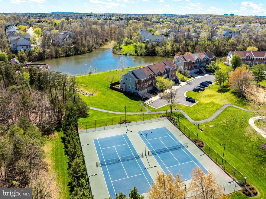 Fall in LOVE.....they did!  Enjoy owning a home on the Lake with some of the most spectacular and expansive water views in Northern Virginia. Located less than 1 mile from the Potomac River, Red Rocks Wilderness Overlook Park and within minutes of Wegman’s, Whole Foods, Downtown Leesburg and One Loudoun Town Center. Here there is something for everyone starting with the premier location within the county and community.  Enjoy the additional benefits of living at the end of a non-through street, adjoining over 20+ acres of dedicated open community space with direct access to the lake, walking paths, community pool, tennis courts and dog park.  This fully updated home offers one of the best interior floor plans designed to accommodate a wide variety of todays at-home activities and needs.  The high ceilings, natural light,  open sight-lines finished-in place hardwood floors and allocation of space, create an open feeling and connectivity that is hard to find! Imagine waking up in the morning to beautiful views, enjoying a cup of coffee or tea from the privacy of your back deck overlooking the lake or taking a quick walk on the community trails.   When its time for lunch or dinner, you will truly enjoy the connectivity, preparing your favorite meal while still conversing with family and friends sitting at your gorgeous kitchen island or gathering room by the fireplace.  When you want to relax, take in the water views from your upper main level family room or head downstairs to watch a good movie or take a nap.  When it's time to unwind and call it a night you have many options.  The upper level offers 3 bedrooms which includes the primary bedroom suite with beautiful water views, luxury bath and closet with built-in’s. The upper level also offers  2 additional bedrooms, a guest bath and laundry. The fully finished walk-out lower level is perfect for entertaining or everyday casual living with a 4th bedroom, full bath, large full size windows across the entire back and direct access to the backyard, outdoor patio and garage.  You will LOVE the full privacy fence, beautiful stone patio, deck and outdoor living space and of course the adjoining open space.  The 2+ garage has additional storage area and additional access from the side yard.