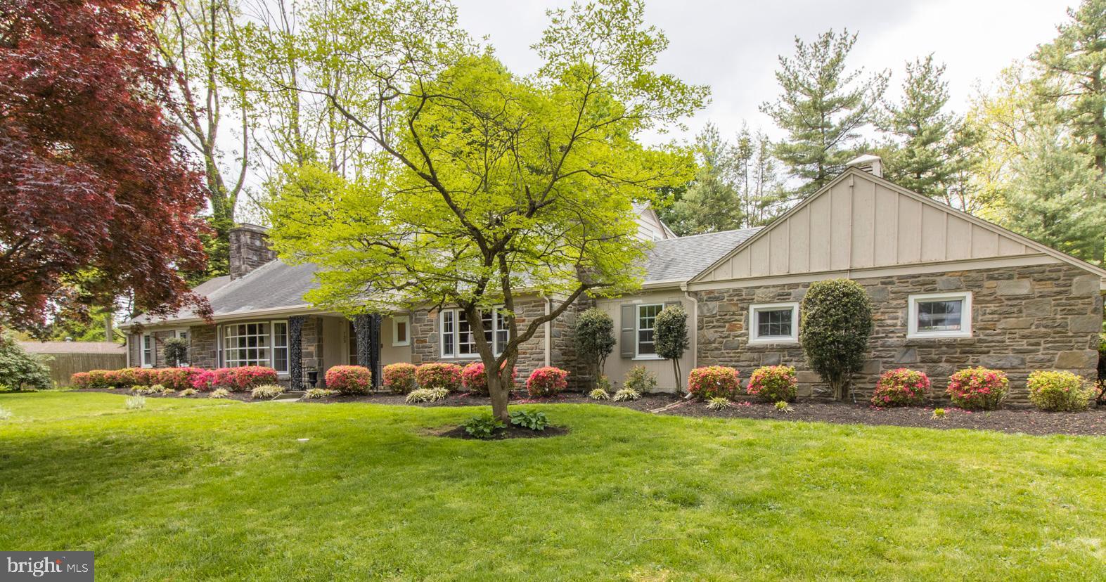 Move into your new home by the time school starts! Welcome to 733 Mustin Lane, an awesome Mahoney-built home on the corner of Mustin and Mount Moro Road set in the estate section of Northside Villanova. This very special, updated stone cape combines the ease of one floor living with beautifully landscaped grounds and outdoor living spaces. With over 3700 sq/ft, 4 bedrooms, 3 full, 2 half baths and 2-car attached garage, this well built home really has it all. The flagstone front pathway leads you to a covered front patio and into the welcoming open foyer with dark oak hardwood flooring and brand new Formal Powder Room . A large, light-filled Living Room with large bay window and wood burning fireplace sets the scene for this delightful home. The formal Dining Room with built in china cabinets complete with serving shelves, crown molding and wonderful picture window looks out to the spacious, level backyard and patio with hot tub, Off the dining room is the eat-in Kitchen with center island featuring white cabinetry, stainless appliances including a new double oven, built-in microwave, pantry and, best of all, a storybook view from the kitchen sink to the atrium patio and backyard. The sliding doors to the covered patio makes it a true extension of the kitchen. A Den with wood burning fireplace and wood beamed ceiling looks out to the front lawn. Mudroom with Laundry, informal Powder Room and access to the Garage complete this wing of the home. Bringing your groceries and packages in is a breeze in this home! A wide hallway leads to 3 bedrooms including the spacious Primary Bedroom and updated ensuite Bathroom, with honed granite vanity sink, oversized shower with frameless glass sliding doors. Two other nice sized Bedrooms on main level are connected by a beautifully updated full Bathroom, with tub and shower. On the 2nd level, you'll find a 4th Bedroom with a deep closet and ensuite Bathroom, which is in the midst of renovation and seller will provide a $15,000 credit so buyer can finish as they like. There is also an enormous versatile Bonus Space that leads to attic storage. Be wowed by the true hub of the home, the amazing open air, covered flagstone Patio complete with lighting, ceiling fan, skylights, hot tub spa and million dollar views. Enjoy nature from your own property or take a short walk down the road to Appleford Estate and stroll through its stunning gardens and grounds. Great location with easy access to Main Line shopping and restaurants, major roadways and train. 30-minutes to Center City Philadelphia, 15 minutes to King of Prussia in the award winning Lower Merion School District. Don’t miss this very special home. If buyers would like, they can be in before the school year!