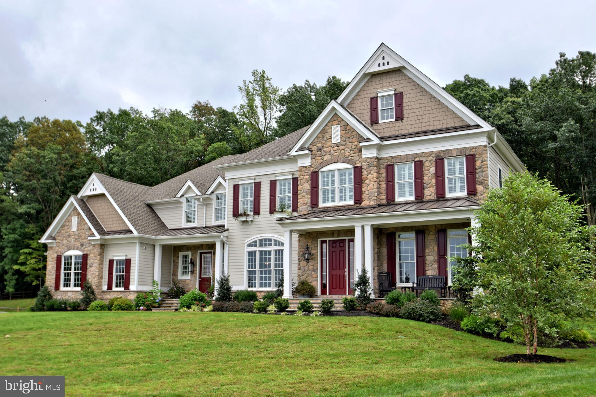 Located in Upper Makefield s highly sought after and prestigious community of Dutchess Farm Estates, this spectacular Toll Brother s Weatherstone Traditional model sits majestically on the highest lot in the community. Backing to woods with gorgeous long distance views of Jericho Mountain, this 1.31 acre end of cul-de-sac lot features immaculate landscaping, including flagstone walkways, ample lighting & irrigation. Barely 3 years old, this property provides a timely opportunity to move right in to this now completely sold out 67 lot estate community. The classic look Stone/Hardie Plank Weatherstone is a newer Toll floor plan and features an elegant single story foyer entry with straight on view out the rear. Impressive 10 first floor ceilings, gorgeous staircase with oak treads and gleaming white spindles and maple hardwood floors, greet you upon entering. To the right is a bright formal living room with gas fireplace and custom marble mantle, to the left the formal dining room and Butler s Pantry. The gourmet kitchen, with large breakfast room and bonus planning center room, features gleaming white 42 cabinets, granite counters, giant center island with seating for four and contrasting color cabinets, and walk in pantry. Appliances include 42 Sub Zero Refrigerator, Jenn Air Oven/Microwave, Jenn Air 6 Burner Range, and Jenn Air Dishwasher. The family room features 12 ceilings, double sided fireplace and walls of windows. A formal office/library, with cathedral ceiling and walls of windows shares the double sided fireplace. The main floor boasts a nicely sized 5th bedroom suite with gorgeous bath, perfect for in-law, guest, or au pair. Mud room entry w/cubbies and plenty of storage space and powder room complete the first floor. The upper level features a luxurious Master Suite consisting of a large sitting room, main area with coffered ceiling, spectacular Master Bath with oversized custom shower & multiple water sprays, Carrara marble throughout, huge walk in closet w/Center Island. Three additional bright and airy bedrooms all with en-suite baths, bonus entertainment/upper family room area, oversized laundry room, and convenient rear staircase complete the upper level. This beautiful, neutrally appointed home features a multitude of structural options and upgrades, including Anderson 400 series windows, Control 4 sound, video and security system, 8 person Caldera Spas hot tub, 3 car garage, expanded driveway parking, 4 zone Heat/AC, and much more. The huge basement, with added ceiling height, offers the opportunity to add your personal design and finishing touch to this magnificent home. Mint, move-in condition. Located just minutes to Newtown and New Hope Boro, in heart of the Council Rock School District.