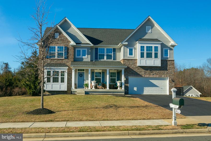 Welcome to 4612 Gate Rd, an exceptional residence in the sought-after Brookside community, thoughtfully enhanced with newly installed hardwood flooring on the main and upper levels. This elegant 9-year-old home offers approximately 5,200 sq ft of beautifully finished living space and backs to 0.64 acres of HOA-owned wooded land, providing a private and serene setting.

Designed for both everyday comfort and upscale entertaining, the main level features a private executive office, formal dining room, and an expansive open-concept family room anchored by a gourmet kitchen. The kitchen is equipped with a large center island, stainless steel appliances, double ovens, gas cooktop, walk-in pantry, and generous prep space—ideal for the discerning home chef.

The upper level showcases four spacious bedrooms and three full bathrooms, including a luxurious primary suite with dual walk-in closets and a spa-inspired bath featuring a soaking tub. A secondary bedroom includes an en-suite bath, while an additional living area and laundry room add convenience and flexibility.

The finished lower level offers an oversized recreation room, a fifth bedroom, and a full bath with a steam shower, creating a perfect retreat for guests or extended living. Outdoor living is equally impressive with a low-maintenance Trex deck, patio, fire pit area, and irrigation system—ideal for refined indoor-outdoor entertaining throughout the seasons.

Residents of Brookside enjoy access to resort-style amenities including two pools, three private lakes, a clubhouse, miles of scenic walking trails, tennis, basketball, and recreational courts, and multiple playgrounds. A rare opportunity to experience luxury, privacy, and community in one exceptional home.