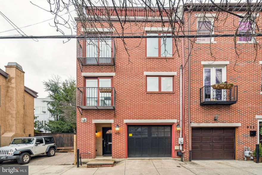 A stunning semi-detached contemporary home on a picturesque tree-lined street in Northern Liberties.
This spacious property offers 4 bedrooms plus an office, 3 full baths, and multiple living areas, including a
formal living room with fireplace, a chef’s kitchen, and a finished lower floor bedroom and family room.
A major 2022 renovation introduced brand-new appliances, a redesigned kitchen, and premium upgrades
throughout. The home features high (15+ foot) ceilings, abundant natural light, and Pella windows and
doors. The kitchen is a showstopper with quartz countertops, a double waterfall island, custom cabinetry,
and engineered hardwood floors, and it overlooks the elegant living room and garden, creating an airy,
open feel.
Outdoor living shines with two rooftop decks—the front with city skyline views, and the rear overlooking the
lush community garden and Ben Franklin Bridge—plus a completely redone backyard deck accessed from
the living room, perfect for relaxing, entertaining, and grilling with friends and family. Multiple balconies—
including two Juliette balconies—add charm and private retreats throughout the home.
The thoughtful layout begins with an entry floor that includes an attached garage and welcoming foyer.
Upstairs, the main floor offers a formal living room with fireplace and the chef’s kitchen overlooking it. The
second floor features two generously sized bedrooms and a full bath, while the top floor is dedicated to the
private primary suite with dual balconies, an office nook, and a spa-like ensuite with a jetted tub. The lower
floor provides a comfortable family room, a fourth bedroom, and another full bath—ideal for guests or
flexible living.
California Closets, recessed lighting, imported wallpaper, and designer fixtures complete the home.
Additional highlights: attached garage parking, quiet yet central location, close proximity and walkability to
public transit and some of the city’s best restaurants, and rare covered off-street parking in the heart of
Northern Liberties.