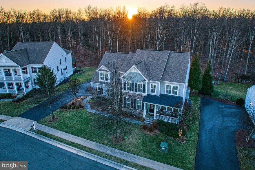 This exceptional home is located on a premium lot backing to trees on the most desirable street in Greene Mill Preserve.  It is loaded with all the bells and whistles and has been immaculately cared for by the owners.  There is room to spare with its 5 bedrooms and 5.5 baths including a finished walk-up basement with a bonus room for guests.  This home is an entertainer's dream, the main level has gorgeous wood floors, crown molding, a formal dining room , formal living room, a large family room with a fireplace all open to the modern kitchen with an island, SS appliances including double ovens, a pantry and a breakfast area with extra cabinets with access to a large deck with a built-in BBQ and PIZZA oven where you can enjoy the beautiful backyard which backs to trees.   The upper level boasts a huge primary suite with sitting room, humongous walk-in closet and a luxury bath, an en suite and two other nice sized bedrooms sharing a jack and jill bathroom.  Don’t miss the second staircase on the main level which will take you to the private retreat where you will find a large bedroom with a full bath.  The lower level has a large recreation room, full bath, bonus room and a large storage room.  Other features include plantation shutters, surround sound, irrigation system and newer HVAC (2021). Greene Mill Preserve is five minutes away from The Brambleton Town Center with it’s movie theatre, grocery store, restaurants and shops and close to the Dulles Airport and Ashburn Silver Line Metro.