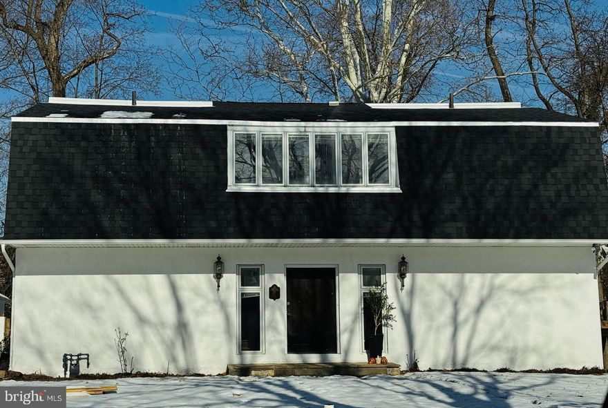 Welcome to Laburnum Lane. Tucked away in a quiet street just off Church Road, this unique mid-century French carriage house–inspired residence was custom-designed by architect Santo J. Lipari, renowned for his exhibition Form, Design and the City. Recently renovated with a brand new roof, new bathrooms, along with other updates, the home blends timeless character with modern updates, featuring original hardwood floors, a grand staircase with its original metal bannister, and expansive living areas filled with natural light. 

The main level offers an eat-in kitchen flows seamlessly into the open dining and living areas, highlighted by a brick fireplace, high ceilings, and two large sliding glass doors that open to a custom patio—perfect for indoor-outdoor entertaining. Outside, the nearly three-quarter-acre, tree-lined lot includes a large detached two-car garage and ample green space. This first floor level also has  a private study or guest bedroom with custom built-ins right next to a stylish half bath, creating an ideal work-from-home or flex-space setup for first floor living. 

Upstairs, you’ll find four generously-sized bedrooms with lots of closet space, clerestory windows and two full baths, thoughtfully arranged to allow easy conversion into primary bedroom suites. These bedrooms  are filled with classic mid-century windows, giving the room access to natural lights throughout the day while preserving the sense of privacy and comfort.

Conveniently located near the restaurants and shops of Jenkintown Borough and just a short drive to the Jenkintown–Wyncote SEPTA Regional Rail station. Locating in a good school district and within just minutes from the city, this green oasis is the perfect place to call home.