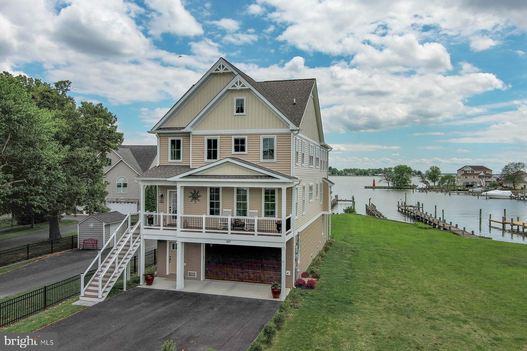 Be the first to experience the waterfront lifestyle at 1117 Chester Road — a just-completed, custom-built retreat where modern luxury meets effortless coastal living. Every inch of this home has been thoughtfully designed to deliver an elevated lifestyle, from panoramic views of Galloway Creek out to the Chesapeake Bay, to high-end finishes that blend form and function.
Come upstairs and enter through the large front porch; it’s the ideal place to end the day and get some shade. Inside you’re greeted by a gorgeous two-story foyer which leads to the open-concept great room. The layout is centered around the remarkable cathedral ceilings and wall of glass with illuminating water views. The gas fireplace anchors one side of the great room yet it doesn't obscure the three walls of water-facing windows. The gourmet kitchen has been thoughtfully designed with a beautiful marble backsplash, quartz counters, custom cabinets and chef’s quality appliances. The kitchen flows effortlessly into the dining and living areas, making it perfect for entertaining or relaxing with family. Oversized windows and sliding glass doors bring the outdoors in, leading to a spacious waterfront deck. Enjoy al fresco dining, morning coffee, or sunrise over the water. From the deck, you can head out to your private pier with 5 ft water depth that offers a boat lift and a jet-ski lift.
The primary suite, located on the main living level, is a serene sanctuary with water views. Two separate walk-in closets provide ample storage and are accented by chic barn doors. The spa-inspired bathroom is fabulous with its walk-in shower, dual sink vanity, and deep soaking tub. Upstairs, you’ll find a large loft area that overlooks the living room and has breathtaking water views. This is the ideal location for an office, additional seating, or a workout area. The two additional bedrooms upstairs are private and spacious, and each has a water view. The hall bathroom features a large dual sink vanity and contemporary fixtures. The ground level includes an immaculate, oversized two-car garage and big, unfinished storage area with windows and glass doors to access the waterside yard. Outside, the level backyard offers space to unwind and enjoy the waterfront breeze.
With state-of-the-art systems, elegant fixtures, and the peace of mind that comes from brand-new construction (including a fire suppression system), 1117 Chester Road delivers a rare opportunity to own a luxury waterfront home without the wait. This location is convenient for boaters – lots of great waterfront restaurants nearby or head to either Baltimore or Annapolis for a change of scenery. Whether you’re seeking a full-time residence or weekend escape in Baltimore County, this is waterfront living at its absolute finest.