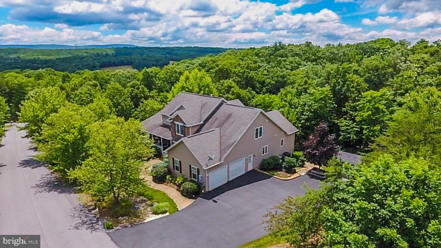 Custom built home with a paved driveway located in Cacapon South. Beautiful hardscaping surround the home and leads up to an inviting covered front porch. Enter through the entry foyer to an open living room, kitchen, dining area with a wall of windows for natural light. Living room features hardwood floors, gas fireplace, and high ceilings. Kitchen features porcelain tile, propane cooktop, Corian counter tops, and separate prep sink. Spacious dining room, breakfast area and counter bar seating provide plenty of dining options. Master Bedroom provides an oasis, with a large walk in closet and Master Bath with double sink, shower and jacuzzi tub. Spacious rear deck from main level for outdoor get togethers.  Upper level provides a large loft for an additional gathering area for friends, family or guests with a large deck from this level. An additional 3 Bedrooms with large closets and bathroom complete the upper level living space. Moving to the lowest level to the perfect party / large gathering space complete with family room/game room with pool table, bar area, propane gas stove, Dining area, exercise room, office, full bath, and tons of storage. But that s not all! Leading from the lower level to a patio, with a path to a fire pit and continuing into the wooded area. Situated on 1.22 Acres but backs to trees providing a private outdoor gathering space. Located just minutes from Cacapon Resort State Park for outdoor activities. Today, the park encompasses 6,115 acres and includes the 48-room lodge with restaurant, 50 year-round cabins, a 6-acre lake, picnic/shelter areas, and 27 miles of hiking trails. A riding stable is also on the property. The  Old Inn  houses twelve to fourteen people for reunions or special events The renovation project, currently under construction, calls for a 67,000-sq. ft. addition with 82 new guest rooms. There will be a new indoor/outdoor pool, a spa and fitness center, new public dining room, and updated kitchen. The Robert Trent Jones, Sr. designed golf course is considered one of the finest in the East, and will get upgrades. Voted USA Today s Top 10 Best Small Southern Town in 2015, Berkeley Springs is a historic spa and art-filled town nestled in the West Virginia mountains only 90 minutes from the Washington/Baltimore metro area. It boasts warm mineral springs, world-class dining, blocks of distinctive shops, full-service spas and more than 100 lodging choices, from elegant B&Bs and historic inns, to cabins and resorts. Golf, hiking, biking and swimming share the schedule with year-round festivals, live music and theater. Friendly people, welcoming mountains and a sense of place mark Berkeley Springs as a getaway for all seasons and tastes.