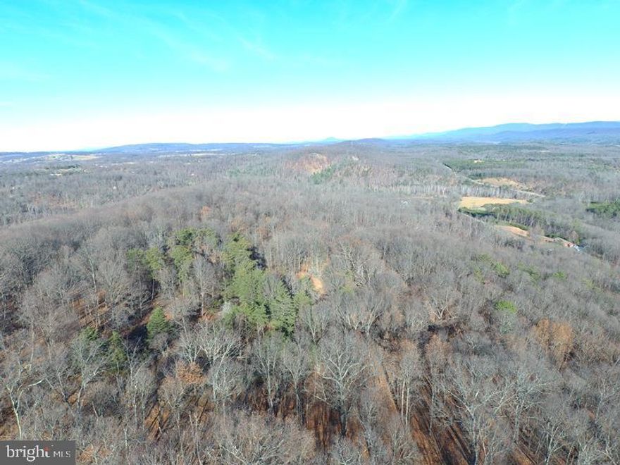 BIG LONELY RIDGE.....20 WOODED ACRES PERCHED A TOP TOWN HILL, ELEVATED AT 1400 FT ABOVE SEA LEVEL, THIS PROPERTY OFFERS YOUR CHOICE OF FANTASTIC VIEWS....TAKE YOUR PICK....SOUTHEAST OR NORTHWEST....YOU OWN BOTH SIDES OF THE BIG WIDE RIDGE.....THE CHOICE IS YOURS AND YOU CAN'T GO WRONG! GENTLY SLOPING OPEN HARDWOOD FOREST WITH TOWERING WHITE OAKS. EXTRA WIDE OLD LOGGING ROAD PROVIDES DRIVEWAY TO RIDGE TOP AND THERE ARE OTHER TRAILS ON THE PROPERTY FOR ATV'S. LOCATED IN QUIVEY'S GROVE, A SMALLER GATED COMMUNITY OF 20+ ACRE TRACTS IN THE CENTRAL AREA OF HAMPSHIRE COUNTY, MORE CONVENIENTLY LOCATED THAN MOST OF THE LARGER 20+ ACRE LOT COMMUNITIES.....CLOSER TO NORTHERN VIRGINIA AND ONLY 15 MINUTES FROM SHOPPING, RESTAURANTS AND HOSPITAL.....YOU'RE OUT THERE....BUT NOT THAT FAR OUT THERE. THIS IS A GREAT LOT, SUITABLE FOR ANY APPLICATION; BUILD, CAMP, HUNT, SHOOT, ATV'S....POWER & PERKED.....THIS ONE'S NOT A ROLL OF THE DICE, IT'S  A WINNER EVERY TIME!