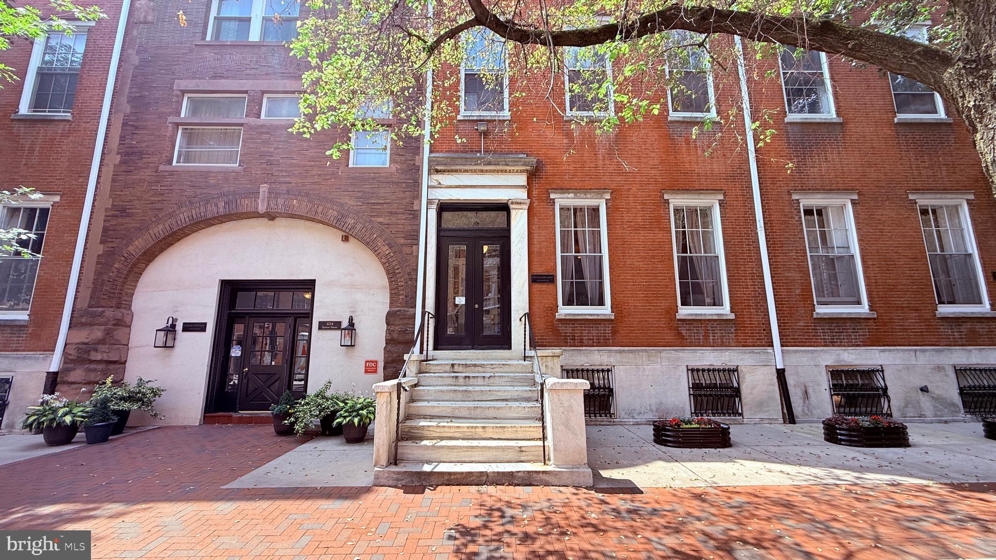 Strickland Row is a private and secure gated community of residences centered by an idyllic courtyard with a beautiful pool! A hidden gem in the heart of Washington Square West. 1016 Spruce St #1R is a newly renovated Condo offering 1 bed, 1.5 bath along with the best of city living with housekeeping, maintenance, landscaping, snow removal, pool access, electric, water, sewer, and garbage covered by the condo fee. A tree-lined street leads to the building's classic red brick facade. Inside the home, the main living space has a very bright and airy feel aided by towering windows overlooking the courtyard and soaring ceilings trimmed by intricate crown molding. A fireplace and hardwood floors add to the character. There's plenty of space here for separate living and dining areas, plus a half bathroom for guests. The loft-style kitchen is fitted with stainless steel appliances, sleek countertops, a tile backsplash, plenty of cabinetry, and a breakfast bar. On the lower level, you'll find a bonus space perfect for an office and a primary suite featuring a very huge bedroom, a luxurious bathroom with a dual vanity, and a walk-in closet that holds the in-unit laundry. Other highlights include newer heating, newer central a/c and newer plumbing. In addition to everything inside, this private, gated community offers two fantastic outdoor spots to spend your spring and summer days. The charming courtyard has a lap pool, patio seating, and gas grills, while the roof deck has benches, tables, and mesmerizing city views! Strickland Row's sought-after Washington Sq W location earns a near-perfect Walk Score of 99! It's close to Center City, yet it has a small neighborhood feel. Local favorites Greenstreet Coffee and Honey Bee Deli are at the end of the block, with picturesque Kahn Park around the corner. Some of Philly's best restaurants, like Little Nonna's, Mixto, Vetri Cucina, & Green Eggs Cafe, are a short walk up Spruce St. There's lots of space to spread out at Washington Sq Park or get active on the tennis court, dog park, and playground at Seger Park. Nearby South St is lined with shops, markets, and eateries, including Whole Foods, ACME, and Starbucks. Plus, there's easy access to Jefferson Hospital, Pennsylvania Hospital, and public transit. Schedule your in-person tour today and dont miss out on your opportunity of owning this beautiful Condo today