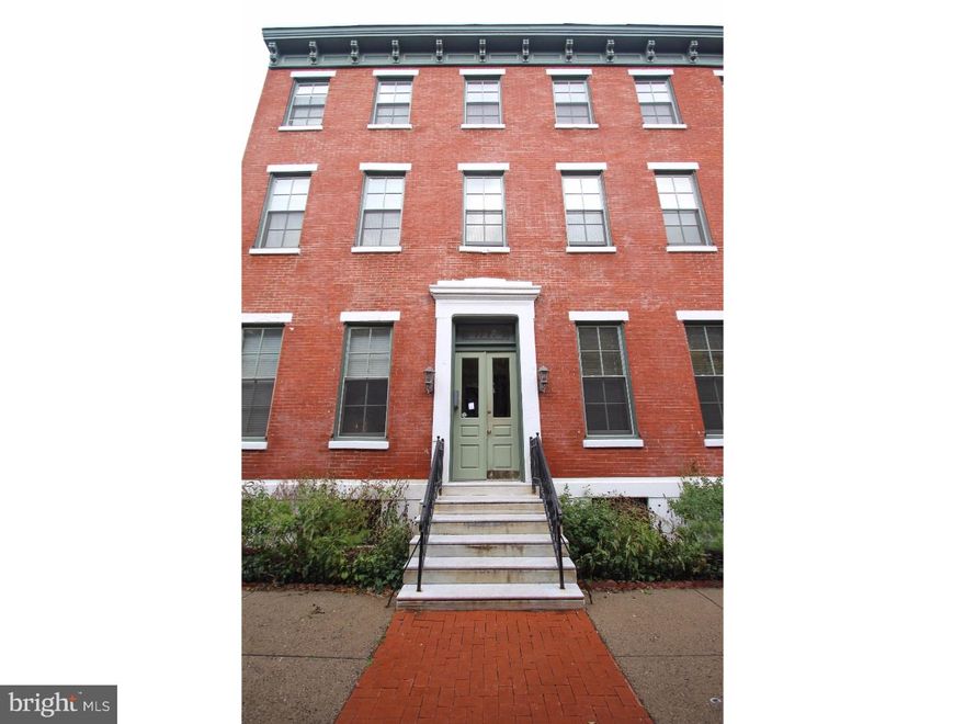 Parking, basement storage and 2 roof decks!! This 1 Bed/1Bath condo is located on the first floor and includes a DEEDED PARKING SPACE (parking area is gated). Hardwood floors run throughout the unit and are complimented by a fireplace and 12 foot high ceilings in the living/dining room. Natural light abounds in the living/dining room favoring the neutrally painted interior. An exquisite pocket door separates the living/dining area from the kitchen. The tiled bathroom houses a Whirlpool/Jacuzzi tub. For the entertainer or griller, there are two communal Roof Decks and a shared Brick Courtyard. A storage area is located in the basement. This gem is within walking distance to the Museums, Boathouse Row & River Drive, Whole Foods Market and various restaurants