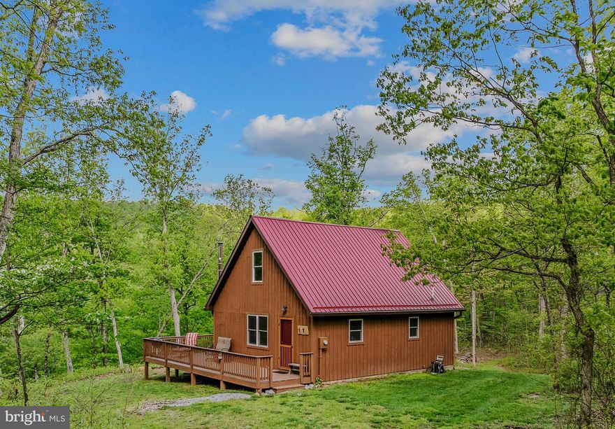 Discover your private retreat with this newer and well-maintained 2-bedroom, 1-bath cabin nestled on over 13 acres offering over 1,000 feet river frontage on the Potomac River! Tucked away at the end of the road, this peaceful haven offers the ultimate in privacy and natural beauty—yet it's just minutes from town. This property offers the perfect mix of hiking, hunting, fishing, and other river activities. Enjoy the private rocky beach or one of two private neighborhood access points & boat ramps. The cabin is perched safely out of the flood plain, and being located directly across from the Paw Paw Tunnel and Chesapeake & Ohio Canal National Historical Park ensures unspoiled views that will never be developed. Inside, enjoy rustic charm blended with modern comfort: vaulted ceilings, recessed lighting, and a cozy loft second bedroom create an open and airy feel. All furnishings and contents convey, making this a truly turnkey getaway.  Bring your suitcases and start enjoying this property right away! An adjoining 11-acre parcel is also available for those seeking even more space and potential. Whether you're looking for a weekend escape, a full-time residence, or an attractive short-term rental on rare riverfront land, this property is a must-see!