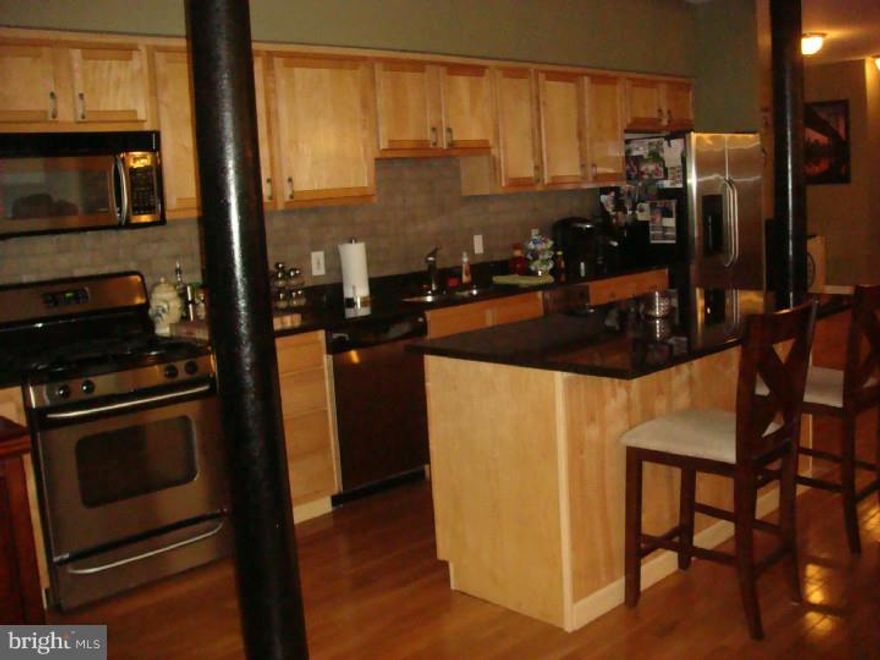 Remarkable 2 bedroom unit with 2 CAR PARKING (1 for garage)! Enter into spacious and wide open floor plan with Sun flooded rooms and maple hardwood floors. Kitchen has mocha colored cabinets, tile backsplash with black onyx granite counters and stainless steel appliances. 2 nice sized bedrooms with ample closet space. 2 full baths with imported Italian tile and glass enclosure shower. Small outdoor area. Laundry room. Home comes with visual intercom security system. Small pets possible with $500 refundable deposit.  Move-in October 1st.
