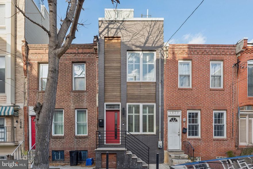 Stunning 3-story, 3 bedroom, 2.5 bath contemporary home in prime Northern Point Breeze (19146) with 3 outdoor spaces: fenced yard off the kitchen, top floor balcony + glorious roof deck with city skyline views! Handsome curb appeal - painted brick with wood accents and a red door with transom. Friendly block. Oversized windows throughout bring in light to give this home a happy feel. Enter into an open layout that's easy to figure out. Plenty of room for your favorite couch and chairs + TV, dining area and a well-appointed kitchen with ample counter space w/bar stool seating. Quartz counters, subway tile backsplash, stainless appliances, gas stove. The kitchen leads to the fenced yard - convenient for pets, al fresco meals, grilling and gardening. Stairs to the finished lower level, with a powder room, makes this area an extension of the first floor. Comfortable space for guests, games, office or meditation/workouts. Up the straight stairs to the second floor, you'll find bedrooms on each side with a modern tiled bathroom with tub/shower in the middle. The entire top floor is the primary suite - with double closets, luxurious bathroom w/double sinks, glass enclosed pebble floor shower. Step out to your private balcony. Bonus: a spectacular roof deck positioned perfectly for spectacular city skyline views. Live at 1825 Gerritt St and enjoy the block, the blossoming neighborhood - Washington Ave has added brew pubs, bakeries, CVS, Aldi and much more - and convenience to Graduate Hospital/Rittenhouse, Penn/CHOP/HUP and University City via the South Street Bridge. Schedule your showing today!