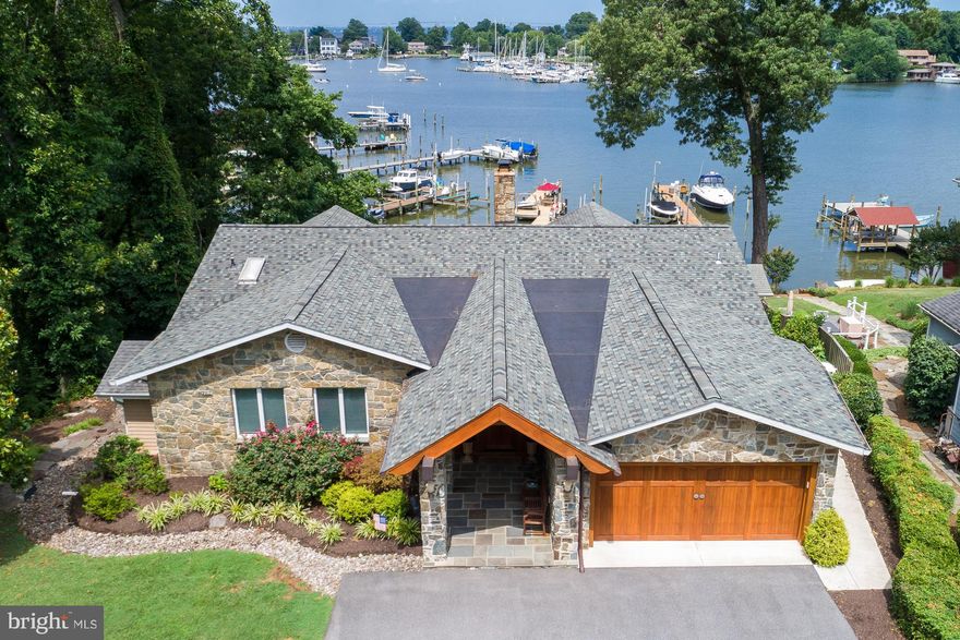 Waterfront on Lake Ogleton - waterside pool and hot tub with hardscape, commanding water views. Striking stone entry w/ vaulted ceilings. Open floor plan, hardwood, stone FP. Main level master.LL walkout, 2nd kitchen, BR, bath, media room. 150' private pier, 75' of waterfront, 4 MLW.