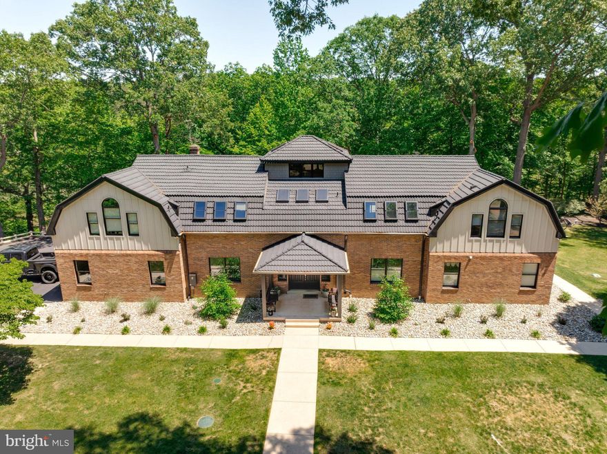 Spectacular Custom Built Waterfront Home resting on a picturesque 5 acre lot surrounded by mature trees. This magnificent Estate has been thoughtfully renovated inside and out. This home boasts gleaming hardwood floors, beautiful exposed wood beams, vaulted and cathedral ceilings, palladian windows, private elevator, skylights, elegant molding, heated bathroom floors, chefs kitchen with double wall ovens, 6 burner gas cooktop with a convenient built in pot filler wall faucet, deep single basin sink, butlers station, walk-in pantry, granite counters with bar seating and matching granite table, the grand master suite walks out to screened porch overlooking Friday’s Creek, spa-like master bath with his and hers vanities, the main level could be independent living for aging parent(s) with 2 bedrooms, ensuite bath and 2nd full bath with sauna shower, full kitchen and laundry and has access without negotiating any steps, finshed walk out basement with game/rec room and plenty of storage space, amazing outdoor living and entertaining with expansive upper & lower decks, front and rear patios, fire pit, camp style outdoor grill, pier & walking in riding trails through the property and down to the waterfront. Attached 3 car garage, detached 3 vehicle garage that is also an apartment with electric, seperate HVAC, full bath and kitchen. This home offers the the luxury and tranquility of a vacation retreat with the convenience of being located within a 30 minute drive to DC, NOVA and Annapolis. Great schools and there is NO HOA!