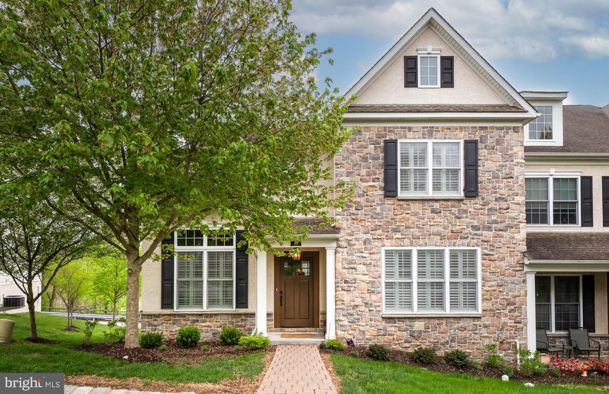 Experience luxury living in this exquisite 3-bedroom, 2.5-bath end-unit carriage home in the sought-after Ravenscliff community. Showcasing timeless elegance, superior craftsmanship, and expansive living spaces across multiple levels, this exceptional residence offers the perfect blend of comfort and sophistication. A charming paver walkway welcomes you to the front entrance. Step inside to a grand foyer filled with natural light, setting the tone for the refined interior. Just off the entry, a private executive office provides the ideal space for working from home or quiet study. The inviting living room flows seamlessly into the formal dining room, creating an elegant setting for entertaining and special gatherings. The spacious gourmet kitchen is thoughtfully designed with stainless steel appliances, abundant granite countertops, a large center island with seating, tasteful neutral backsplash, and extensive cabinetry for storage. A stylish butler’s pantry complete with a wine refrigerator adds elegance and convenience, offering additional prep space and storage for effortless entertaining. The stunning two-story family room features oversized windows and a striking wood-burning fireplace. The luxurious first-floor primary suite is a private retreat, highlighted by soaring ceilings, two walk-in closets with custom organizers, and a spa-inspired bath featuring a soaking tub, dual vanities, and a floor-to-ceiling tiled shower with a frameless glass enclosure. Hardwood flooring extends throughout the main level. Both the family room and primary suite offer access to the rear deck with low-maintenance Trex decking, perfect for outdoor dining, relaxing, and enjoying the surrounding views. A powder room and laundry room complete the main level, along with the option to install an elevator servicing all floors. Upstairs, you’ll find two generously sized bedrooms, each with spacious walk-in closets, a full hall bath, and an expansive loft area offering endless flexibility as a home office, media room, fitness space, or additional lounge area. The lower level presents incredible potential for future finishing, offering abundant recreation space, large windows off the back of the home, rough-in plumbing for a bathroom and space for an elevator to be installed. Additional highlights include a paver driveway leading to the attached two-car garage, custom wood shutters throughout, and numerous upgrades throughout the home. Ideally located near shopping, dining, parks, schools, and major highways, and just minutes from everything vibrant Media Borough has to offer, this home truly delivers the best of luxury and convenience. Don’t miss the opportunity to make this remarkable property your own. Schedule your private showing today!