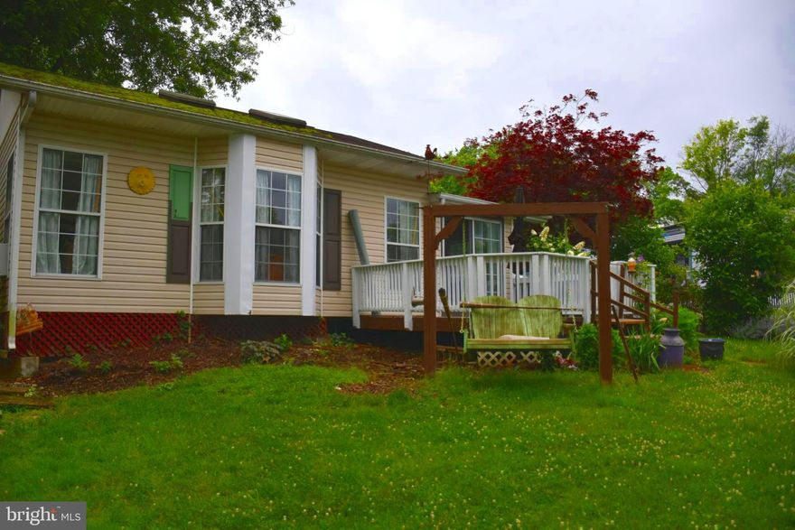 Check out this River Bend camper with 2 bed, 1 bath, an addition and an additional lot! The home has a living room and dining room with gorgeous new flooring and a fireplace! Enjoy some natural light in the sun room or a quiet hideaway in the loft. Relax and enjoy fun for all including swimming pools, miniature golf, playground, basketball hoops, tennis courts, baseball field and horseshoes. Bring your boat for water activities. A nice sized deck for you to sit and overlook the additional lot that conveys. Electric, Water, Sewer and Trash are included in the Riverbend Membership Corp. Only an hour from the Greater DC area.