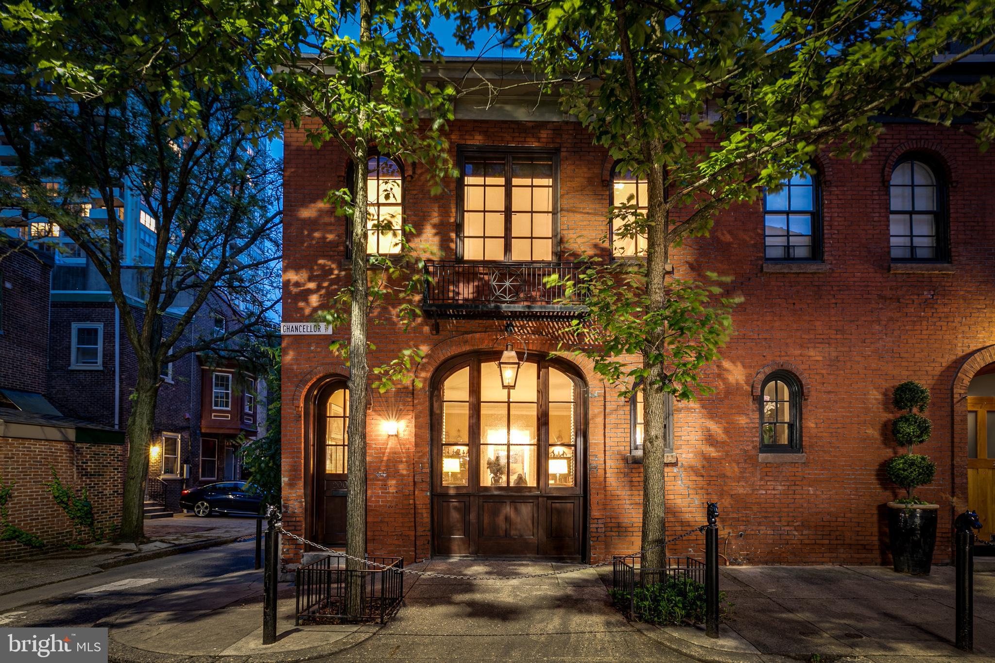 There’s something about a carriage house that is particularly fascinating; it might be the arched doorways, brick facades, or the fact that they belong to an entirely different era. This 2400 sq ft corner Carriage House... Uniquely Philadelphia... Contemporary Architectural Design... Open Floor Plan... is a dramatic 2 bedroom plus den home unlike any other. From the striking landmarked mahogany multi-windowed façade of dark wood and old brick to the light-filled differently defined levels for living, this carriage house will excite just crossing the threshold. On the entry-level is an open living and dining with fantastic handmade moldings and a fireplace. The center hall features wood floors from Bologna with a sleek steel and wood staircase. Adjacent there is a full laundry room and powder room. Walk into the windowed cook’s kitchen with amazing storage and eat-in dining. The beamed ceiling is original to the carriage house and there are double mahogany doors that lead to the rear of the property. Up one flight to the den/library sit and relax with your favorite book and a cafe. This level features the primary suite with walled bookcases, walk-in closet and en-suite bath with water closet. There is a 2nd bedroom also with an en-suite bath and a walk-in closet. Then it is up to the beautifully decked and planted roof garden. Traversing the center of the carriage house is a skylight that brings in magical light day and night. Located on the most desired Chancellor Street in the heart of Rittenhouse Square, one of the most sought after Rittenhouse brownstone neighborhoods, you are near shopping and world-famous museums plus fine food purveyors, and an electrifying array of restaurants and bars. Words do not capture this unique and dramatic home so to really appreciate it you must see it yourself!