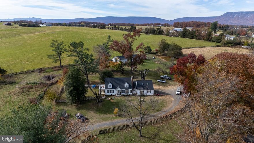 FARMETTE on 5.3 acres in the heart of Luray! A PROPERTY LIKE THIS IS TOUGH TO FIND. This 4 bed, 2 bath home is surrounded by farmland & mountain views. Features tons of natural light, hardwood floors throughout, 2 first floor bedrooms, and a large recently updated kitchen with white cabinets, nice laminate counters and stainless steel appliances. The kitchen also has new floors and a huge pantry, perfect for additional storage.  Attached 2-car garage has a 24x14 Upper Bonus/Guest Room great for expanding + the full unfinished basement has room for storage & more! Property includes: spring fed POND, 72x36 BARN with all the accessories: Electric, Hot/Cold Water, Tack Room, Office Space, etc and the entire 5.3 acres is fully fenced. RAISE ANIMALS: horses, goats, pigs... PLANT A GARDEN & LIVE off of this land! New roof installed on the house and garage in November 2025. Additional repairs to be made to the rest of the home in November from recent storm damage. Basement to be fully resealed and many other repairs to be made in the next 6 weeks. Ask agent for more details.