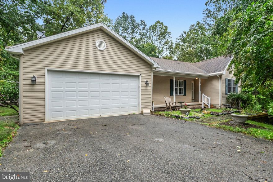 This charming ranch-style home offers a peaceful retreat on a spacious 1.17-acre fully fenced lot. Step onto the covered deck to savor the fresh air and take in the tranquility of your private oasis.  Approach the front porch and inside, an open floor plan creates an inviting atmosphere, featuring a dining area highlighted by decorative columns and refinished hardwood floors. The living room is the heart of the home, complete with a cozy gas stone fireplace. From there you can step out onto your covered porch and truly soak in the beauty of your backyard while enjoying some fresh air rain or shine!

The beautifully upgraded kitchen is a chef’s dream, boasting a stylish backsplash, a stunning double sink, and SS appliances. The private primary suite includes a large walk-in closet and an ensuite bath with a dual vanity, offering a relaxing escape. Newly installed luxury vinyl plank (LVP) flooring enhances the kitchen and all bedrooms for a modern touch.

Convenience is key with main-level laundry, featuring ample space to fold clothes. Two additional well-sized bedrooms share a full bath. Downstairs, a full unfinished basement provides plenty of storage and potential for customization. Walk out access leads to a lovely stone patio with steps that curve around to bring you up to the front of the home. Tucked away on a secluded lot, this property offers the perfect balance of privacy and comfort, making it a true hidden gem in Shannondale.