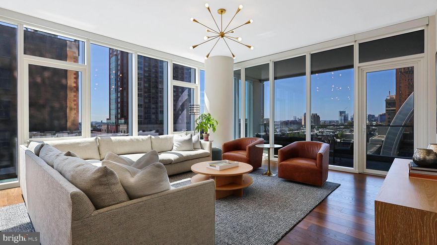ONE OF THE FIRST RESALE OPPORTUNITIES AT ARTHAUS. Tax abatement through 1/30/2033.  Approximately 100k in seller upgrades ( Automated Lutron shades, custom closets, light fixtures). This is a D-Line SW corner unit wrapped in glass with prime sunset views. 2 Bed, 2 bath, 1,730 sq ft, valet parking, weather protected terrace, BMW 7-Series House Car. The gourmet kitchen is a culinary haven, Poggenpohl cabinetry, integrated appliances by Wolf, Bosche, Sub-Zero and Asko providing a seamless aesthetic . Adjacent to the kitchen, a fully-equipped laundry room with additional storage space. The primary suite is a serene sanctuary, complete with a spacious walk-in closet with custom built-ins and a luxurious ensuite bathroom designed to evoke a spa-like experience. The second bedroom is equally refined, offering ample custom built-ins and nearby access to a beautifully appointed second full bathroom. The current owner has enhanced all closets throughout this home with custom luxury built-ins in solar white, providing an abundance of organized storage and uniformity. Adding to the home's modern appeal, the current owner installed automated Lutron shades throughout the entire residence, allowing you to effortlessly control the ambiance and privacy of each room with the touch of a button. This distinguished residence boasts an array of world-class, resort-style amenities, including rooftop glass-enclosed greenhouse ( first of its kind), outdoor terrace, with seating, firepit and reflecting pool, 75-foot indoor lap pool with hot tub, fitness center overlooking the Kimmel Center, gardening beds, sundeck and lawn offering skyline views, grill stations, locker room with sauna and steam room, library, board room, club room, catering kitchen for private chef dinners, outdoor dog run and dog spa, laundry room for oversized items, cafe with demonstration kitchen. This home comes with 1 car parking,  additional parking licenses are available for purchase. Pet friendly building up to 75 lbs.