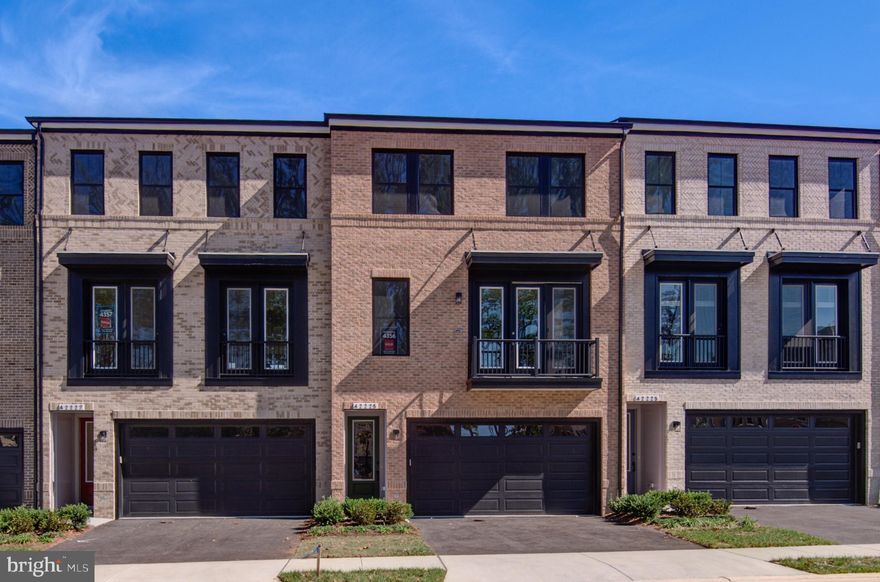 NEVER LIVED IN! Brand new construction! Built by Vanmeter Homes, located in West Park III Section, a part of the award-winning, master-planned Brambleton community w/exceptional lifestyle, convenience, & connectivity<br><br>AT A GLANCE: Luxurious Grandeur! 24 ft wide, brick front, premium elevation w/36 sq ft balcony | 3 level TH w/2816 finished interior sq ft that flares w/3 spacious bedrms, 3 full bathrms, & a main level powder | Covered front stoop | Glass front door | Attached front load 2 car garage + a driveway that comfortably fits 2 cars | Ample guest parking spaces available at the front street | Luxury Vinyl Plank (LVP) flooring @ main level & upper hallway | Oak staircase @ two flights | 9 ft ceilings on all 3 levels w/8 foot doors @ few areas which gives an illusion of 10 ft. ceilings | Ample of recessed lights & windows thru out for gushing natural sunlight | Media points at apt locations | Fronts to trees | 200 sq ft deck<br><br>MAIN LVL: Gourmet kitchen w/ample of upgraded cabinets, humongous center island, SS appliances, quartz counters, quartz backsplash, undermount sink & a walk-in pantry | Flowing living & dining areas w/a balcony | Spacious family rm w/ a fireplace that opens to a deck | Tucked in powder room
<br><br>UPPER LVL: Warm owner's suite w/a walk-in closet. Primary bath w/dual vanities, standing shower, & a water closet | 2 spacious secondary bed rms that share a hall bath | Linen closet | Washer & Dryer closet<br><br>LOWER LVL: Enter the home thru the lower level where the two-car garage access & the foyer lead to a hallway that opens to a large recreational area | A full bath | Storage Closet | Walk-out homesite that opens to the backyard<br><br>HOA FEE INCLUDES: Community Verizon FIOS package for cable & internet, lawn mowing, trash, & snow removal<br><br>HOA AMENITIES: Access to 5 community pools, 18+ miles of paved trails across the neighborhood, 3 club houses available to rent, a wide array of parks, beautiful laid ponds w/fish, lighted tennis, sand volleyball, & basketball courts, dog park, little library, tot lots, & minutes from Brambleton Regional Golf Course | Association offers programs like art, dance, drama, summer camps for all ages, & exciting community events organized throughout the year<br><br>BRAMBLETON TOWN CENTER: State of the art library, farmers market, grocery, movie theatre, fitness, gas station, restaurants, pharmacy, boutiques, meeting places, & much more<br><br>UNBEATABLE HEART THROB LOCATION: Minutes to HAL & BERNI HANDON REGIONAL PARK (a 257 acre park) right behind; check the site map at pictures | Access to major commuter routes like NorthStar Blvd, Belmont Ridge Rd, Loudoun County Pkwy, 267 Greenway/Toll, Rte 50 | Close to recreational areas, intricate trail network, public transportation, Ashburn Metro (Silver Line), NOVA, Dulles International Airport, Loudoun Station, Broadlands Village, One Loudoun, Dulles Landing, & much more