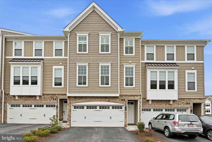 Welcome to 12 Lila Lane, a beautifully maintained 3-story townhome in the desirable Townes at Chester Springs community. Built in 2019, this home is loaded with over $50,000 in upgrades and offers a modern, open layout designed for today’s lifestyle.The main level features a bright and airy open floorplan with a spacious living room at the front, a convenient powder room, and a stunning gourmet kitchen at the center of the home. The kitchen boasts an oversized island, upgraded KitchenAid appliances, and flows seamlessly into the dining and family room areas—perfect for both everyday living and entertaining. Sliding glass doors lead to a private back deck, ideal for relaxing or hosting guests.
Upstairs, you’ll find three generously sized bedrooms and two full bathrooms, along with a conveniently located laundry closet. The primary suite is a true retreat, featuring a large walk-in closet and a luxurious en suite bathroom with a double vanity and a glass-enclosed shower with subway tile extending to the ceiling. Two additional bedrooms offer ample closet space and share a well-appointed hall bath.The lower level provides a versatile den or additional family room with sliding glass doors to the rear exterior, along with a welcoming entry foyer and access to the attached two-car garage. Additional highlights include custom plantation shutters throughout and a large storage closet on the first floor. Located in the award-winning Downingtown Area School District and just minutes from shopping, dining, and outdoor recreation, including Marsh Creek State Park, where you can enjoy hiking, biking, kayaking, fishing, and more—this home truly has it all.