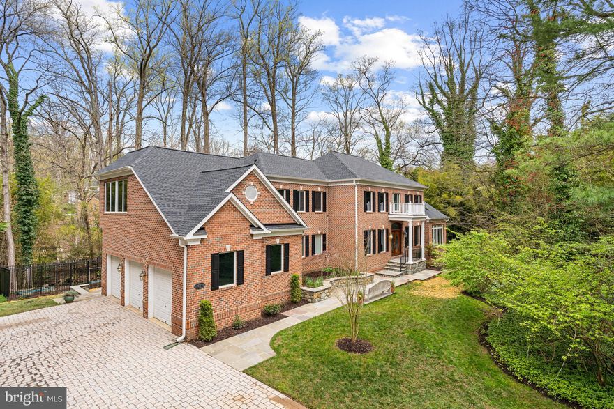 Georgian architectural masterpiece nestled in sought-after Luxmanor offers unparalleled luxury and privacy. From the moment you step through the grand double doors into the two-story entryway, you're enveloped with high ceilings and spacious rooms adorned with custom finishes and quality built-ins. The main level boasts lavish spaces for relaxation: A wood-paneled library with a fireplace, a sunroom with walls of windows, and a central family room with a stone fireplace. The chef's kitchen is a culinary dream, equipped with high-grade granite, natural cherry cabinetry and top-of-the-line appliances from Jenn-Air & GE Monogram including two dishwashers and twin refrigerators. Upstairs, the primary suite is a haven of tranquility, featuring vaulted ceilings, a gas fireplace, separate full bathrooms for both partners, custom walk-in closets, and a corner study with oversized windows offering serene views. The lower level is an entertainer's delight, featuring high ceilings, built-ins, spa amenities including exercise rooms and a sauna, as well as an additional bedroom and full bathroom. Ample storage is provided throughout the home, including closets and larger storage areas. Other highlights include 3-zone HVAC, Pella windows, refinished Brazilian cherry hardwood floors, custom craftsman-built shelving and a wine cellar. For outdoor enjoyment, there is new Trex deck, a beautiful stone patio and a tumbled paver driveway. Gardening enthusiasts will appreciate the enclosed, deer-proof garden area with raised beds. The entirety of this special home has been freshly painted and adorned with new carpeting offering unique features rarely found elsewhere.