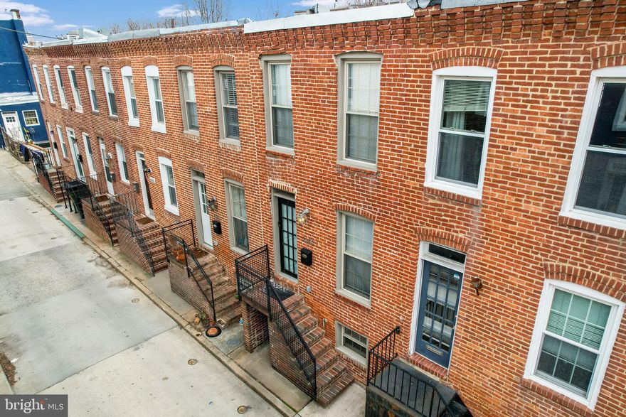 Location, Location, Location!! Super 3-bedroom, 2-full bath brick townhome with three finished levels in sought after Federal Hill. Main level features a living room with a full floor to ceiling brick accent wall, hardwood flooring and recessed lighting. Also on the main level is a beautifully updated kitchen boasting light maple cabinets with crown moulding, granite counter-tops, breakfast bar and stainless appliances. 5-burner gas stove for the cooking enthusiast. Off the kitchen you will find a rear deck ideal for grilling. Access the 2nd level via an eclectic black metal staircase with wood treads and open risers. There you will find two nice size bedrooms – one with a classic full brick accent wall. Upstairs also features a newly professionally updated full bathroom with double sink granite vanity and a gorgeous walk-in tiled shower. The recently finished lower level has another full bath with a tiled shower/jetted tub and a 3rd bedroom/family room that has a convenient separate entrance. The HVAC (gas heat) & A/C is less than a year old along with the roof being less than 3 years old. BONUS: There is inside access to the fabulous rooftop deck with expansive views of Federal Hill and M&T Bank/Ravens Stadium. Enjoy entertaining around the gas fireplace and fantastic skyline views. Deck furniture, gas fireplace, grill and deck string lights convey. Only a short walk to downtown Federal Hill restaurants/bars/gyms/Ravens & Orioles Stadiums. Enjoy all that living in Federal Hill has to offer!!