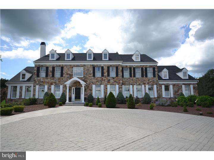 Backing to 100+ acres of preserved land with spectacular long distance views, this stone estate manor home sits on a premier 1.61 acre parcel in River Crossing. Enter the two story, curved staircase foyer with marble flooring. Center Hall colonial with custom millwork has beautiful living and dining room. French doors off formal living room open to exquisite conservatory with fireplace. Family room has wet bar, stone fireplace and magnificent back yard views. Gourmet kitchen with vaulted ceiling in breakfast area has stainless steel appliances, granite and travertine back splash. Two story breakfast room opens to sun drenched sunroom with views of Bowman's Tower and Jericho Mountain. Office and laundry room complete the first floor. Upstairs is a sumptuous master bedroom suite with master bath. Princess suite and Jack and Jill suite complete the upstairs; all bedrooms are large and spacious. Incredible finished lower level with two bedrooms, wine room, media and entertainment room and beautiful full bath. Arguably the most spectacular lot in River Crossing, one of Upper Makefield's most desirable neighborhoods. Spectacular long distance views from every window of the house including views of Bowman's Tower while you are relaxing on the back patio with gas fireplace. Professional landscaping and hardscaping with circular, paver drive way. Stunning estate home in the heart of Upper Makefield.