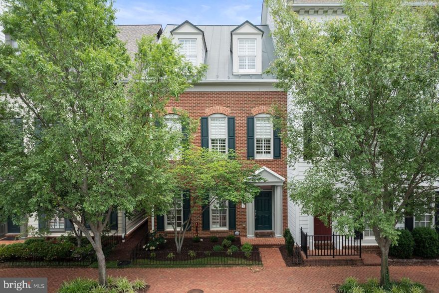 NEW PRICE! Welcome to this all brick, end-unit townhome in the sought-after Potomac Greens community. This 3-level, carefully maintained residence features 3 spacious bedrooms, 2 full baths, and 2 half baths, thoughtfully designed across multiple levels to suit a variety of lifestyles. Step inside to a welcoming entry level that includes a foyer, half bath, a versatile office and cozy den, ideal for working from home or relaxing in style. The 2-car garage with electric car charger offers ample storage space, adding to the home’s practicality. 10+ foot ceilings, exquisite moldings, wainscoting, and plantation shutters throughout lend timeless elegance. The main living area features a double-sided fireplace, warmly connecting  the family room and dining room. Enjoy everyday meals in the sunny breakfast area just off the kitchen, complete, kitchen island, pantry and premium finishes. Upstairs, the primary bedroom suite offers a serene retreat with an ensuite bath, walk-in closet, and an additional closet for extra storage. Two more generously sized bedrooms provide comfort for family or guests. Close to the  Potomac Yard Metro trail, this location is a commuter’s dream — minutes to Old Town Alexandria's Historic District,  Amazon HQ2, Virginia Tech Campus, Washington, D.C., and more.  Or bike to work on the adjacent Mount Vernon Trail with views of the Potomac.  As part of the vibrant Potomac Greens community, residents enjoy access to plenty of community events throughout the year, a pool, fitness center, and a connected, neighborly lifestyle. Don’t miss this opportunity to own a refined townhome in one of the area’s most desirable neighborhoods! Recent updates and features include: new furnace (2025), AC compressor 1st and 2nd floors (2021), air handling unit for 3rd floor (2021), standing seam metal roof (life expectancy of 50-100 years), plantation shutters, freshly painted (2025), new carpet in bedrooms (Dec. 2024), Tesla electric car charger, and more (see special features sheet).