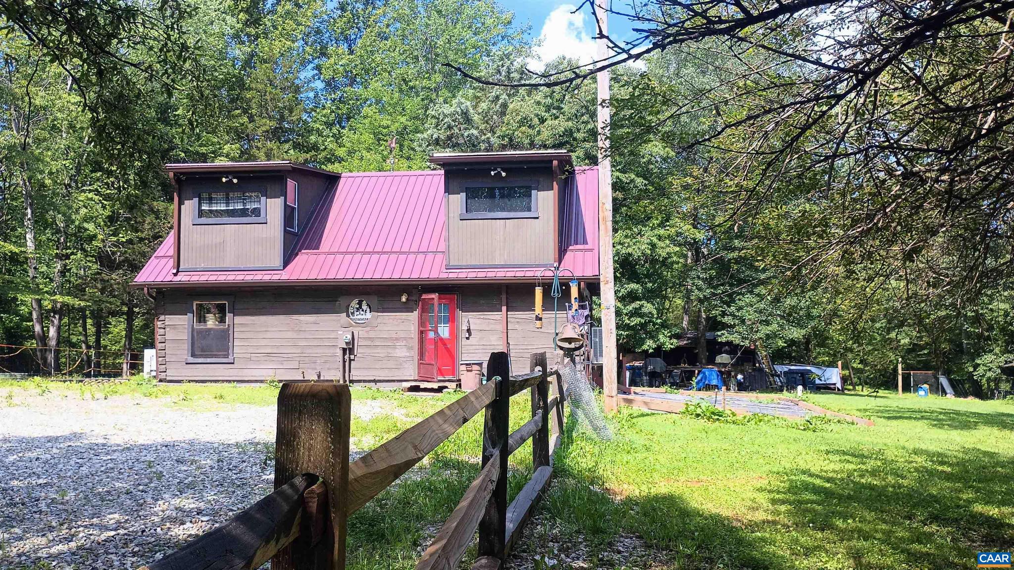 This very private property is surrounded by woods. The log home was designed with the addition of solar panels in mind. The 3 bed, 1 1/2 bath property provides a good opportunity to acquire a small homestead where the hard part has been done, and you can develop as you wish. The property is set up with shelters and pens for chickens, a goat, and a pig, with space for a large veg garden, or a couple of horses. The well has good water. There are 2 storage sheds (12x20) for lumber, firewood, 4 wheelers, boat etc. There is a workshop (20x20) with a 10x20 lean to. A greenhouse is under construction. There is also a little cottage/shed in the front yard. The National Forest, Crabtree Falls, Tye River etc. are close by, in this quiet part of Nelson County. Firefly broadband is installed. Lynchburg is only 35 minutes away, and Charlottesville is 50 mins. Only 15 mis from Lovingston with grocery stores, banks, breweries, wineries, restaurants, medical center etc. Perfect for part time or full-time country living.