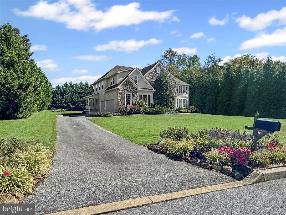 *Coming Soon* Spectacular Pondview center hall Colonial; former model home nestled on a premium .7 acre private, level lot; one of the deepest most functional lots in the community featuring a lovely tree lined backyard for privacy, with lots of lush landscaping and beautiful gardens; perfect for large gatherings or a pool if desired, situated in the heart of Garnet Valley and top rated Garnet Valley schools. A beautiful updated paver front walkway and raised flower bed flank a grand stone facade and James Hardie Plank exterior, with a charming portico that greets you at the main front entrance. As you walk into a breathtaking entrance hall with a beautiful turned staircase, you're greeted by endless upgrades & high quality finishes including custom millwork, gleaming Brazilian Cherry wood floors that flow throughout the main level of a lovely open floor plan, 10' ceilings and much more. Only available due to downsizing, this fabulous upgraded & lovingly maintained home has 5 spacious bedrooms with ceiling fans on the upper level plus 3 full baths and lots of spacious closet space. The luxurious master suite is exceptionally grand & spacious; featuring a tray ceiling, crown moulding, a large sitting area, two walk-in closets, and a fabulous updated tiled en-suite master bath with a large soaking tub, an oversized walk in rainfall shower, his & her vanities and a separate water closet. For added convenience, the laundry room is also situated on the upper level. The main level living area features a spacious family room with a cozy fireplace, new carpet (2024), a breezy ceiling fan, and added crown moulding, ceiling moulding & decorative beams; and is adjacent to the gourmet kitchen that has lots of beautiful high end 42" cabinetry, an oversized center island, a convenient pantry, stainless appliances including double ovens, dishwasher, cooktop, range hood and french-door refrigerator, lovely granite counters and a beautiful sunny morning room featuring a vaulted ceiling with crown and ceiling moulding, that walks out to a fantastic enclosed screened rear porch addition (added in 2014) with skylights and an expanded & updated rear Trex deck looking out over the tranquil, private, deep rear yard flanked by trees and lots of lush gardens. Also adjacent to the kitchen is a grand formal dining room with crown moulding and chair rail. Across the center hall from the dining room is a large living room with crown moulding, and there is a spacious private office, as well as a conveniently situated half bath with an updated vanity. Also off the kitchen is a side hallway that leads to a spacious garage for three cars and all your toys, and a side entrance with an updated porch that has an enlarged roof, Trex decking and a Trex bench that walks down to the driveway for added convenience. This hallway also has a second "back" staircase leading upstairs. The dry walk up basement has high ceilings and roughed in plumbing should you desire to finish the basement for added living or entertaining space. Centrally located to the Garnet Valley School Campus, the Concord Township Park, walking & running trails, dog parks, Rachel Kohl Library the Brandywine Youth Club sports fields & field house, dance studios, Darlington Arts Center, & all commuting routes to corporate centers, Delaware tax free shopping, airports, Philadelphia, Wilmington, Media, West Chester & more. This exceptional well maintained home underwent a complete exterior renovation in 2014, with James Hardie Plank and all new windows and exterior doors. The home has also been updated with two new high efficiency Lennox HVAC systems (2020), a new Kohler whole house generator (2023), new water heater (2024), new roof (2015) and the rear yard was expanded with the removal of 30+ trees to create the largest functional yard in the neighborhood; but is still flanked by trees for peace and privacy. Showings begin September 20th; open house scheduled for September 28th 12 PM to 4 PM.